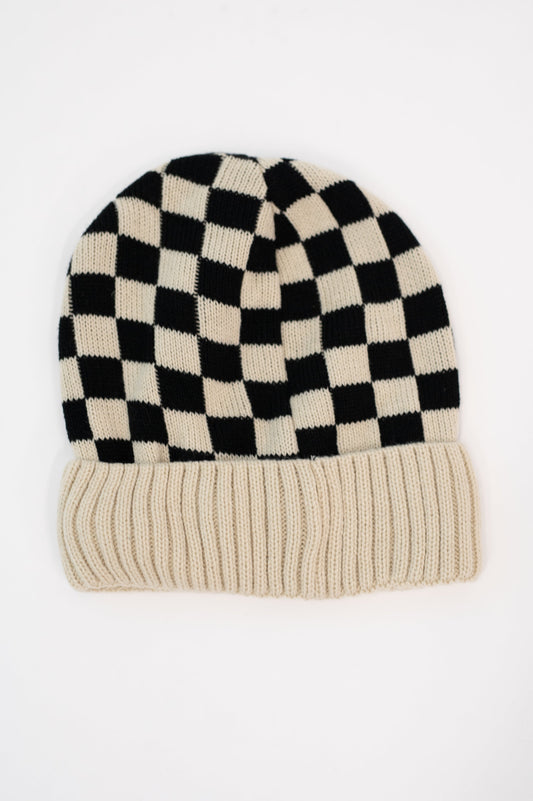 Flat lay of Checkered Weather Beanie in Bone with ribbed hem and soft knit.