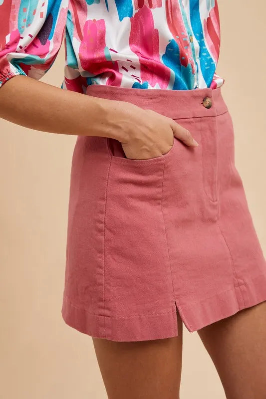 Close-up of Dina cotton mini skirt – flattering fit and edgy slit.