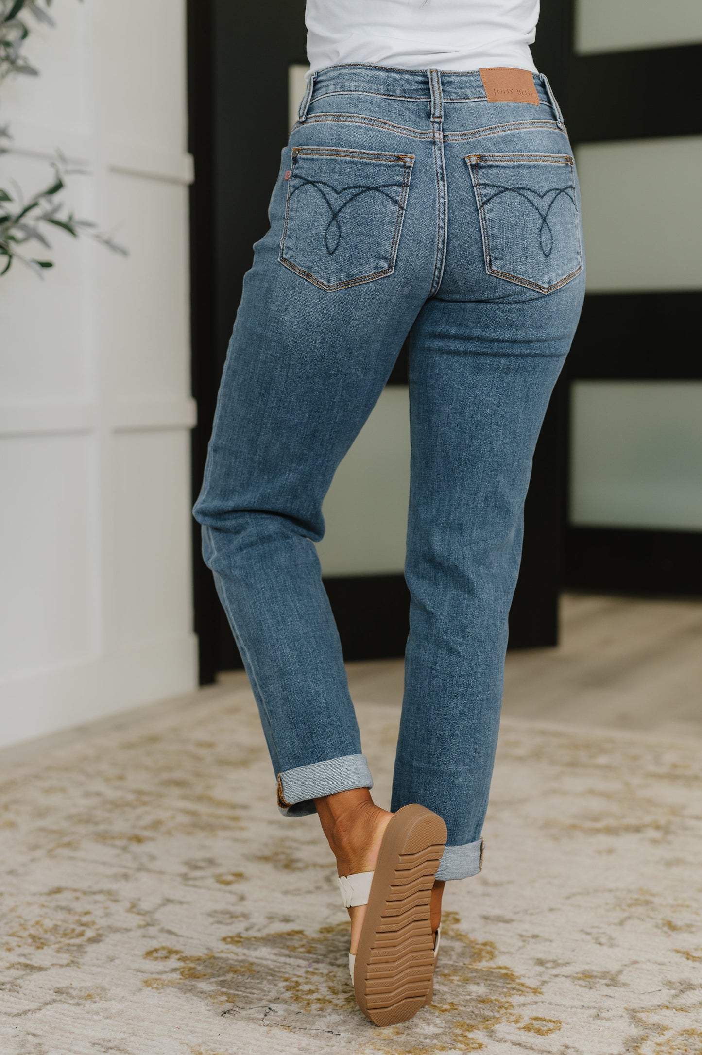 Back view of dark wash Colette Boyfriend Jeans featuring flattering mid-rise and relaxed fit.