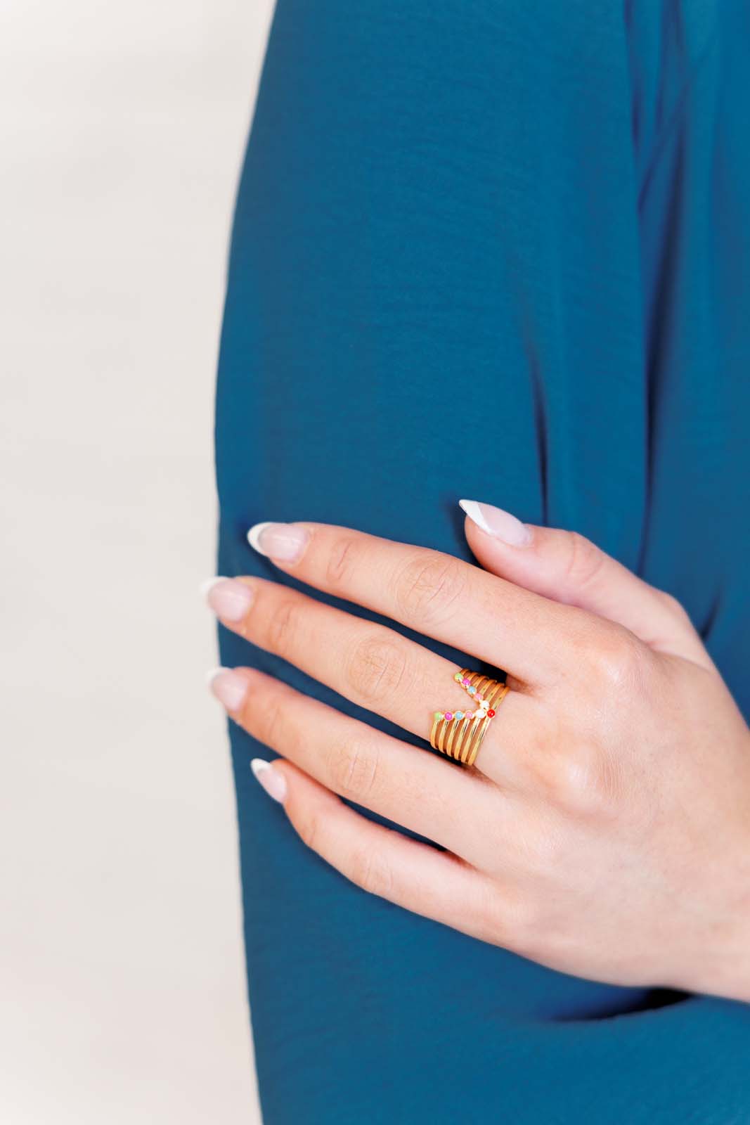 An 18K gold-plated stainless steel adjustable ring, with multi colored design hypoallergenic and water-resistant, designed for everyday wear.