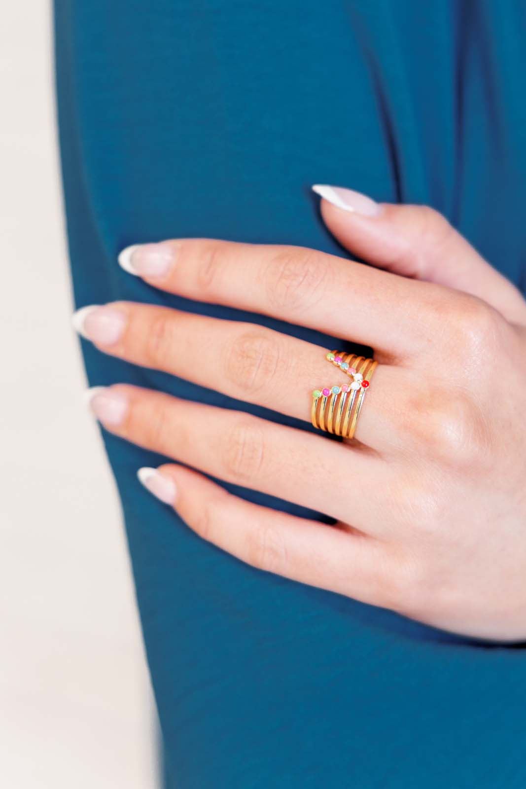 An 18K gold-plated stainless steel adjustable ring, with multi colored design hypoallergenic and water-resistant, designed for everyday wear.