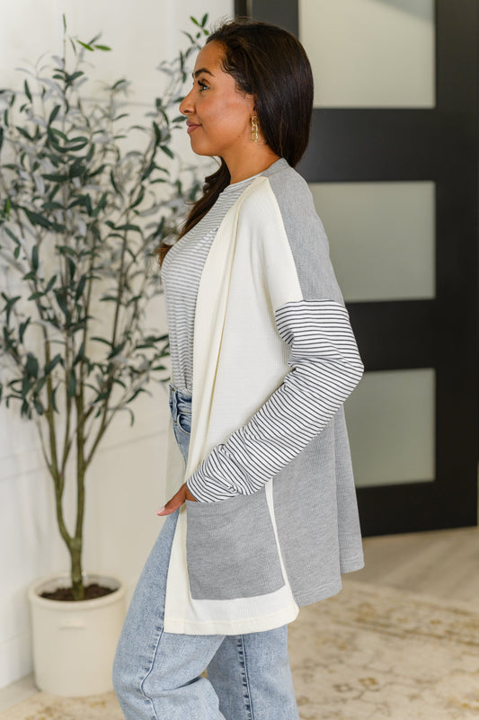 Side angle of Evie cardigan showing drop shoulder silhouette and waffle knit with jersey contrast.