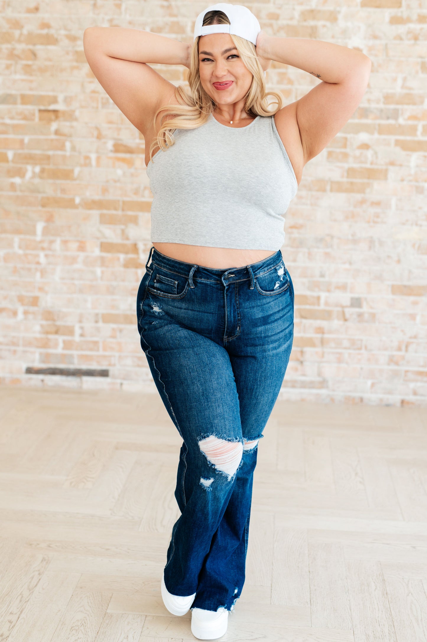 White cap with an adjustable Velcro strap.