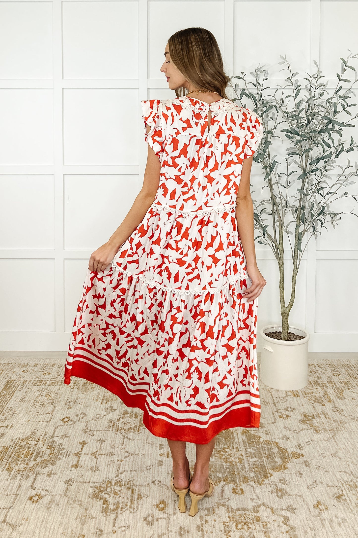 Back view of Daine Tiered Dress with keyhole closure and lace trim detail.