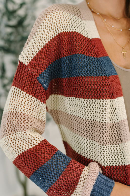 Close-up of Carly Striped Knit Cardigan texture showing net knit and ribbed hem detail.