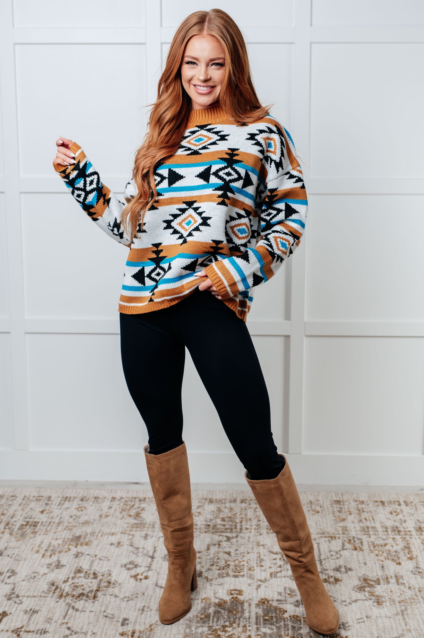 Full body view of model in Anza Geometric Striped Sweater styled with leggings and boots