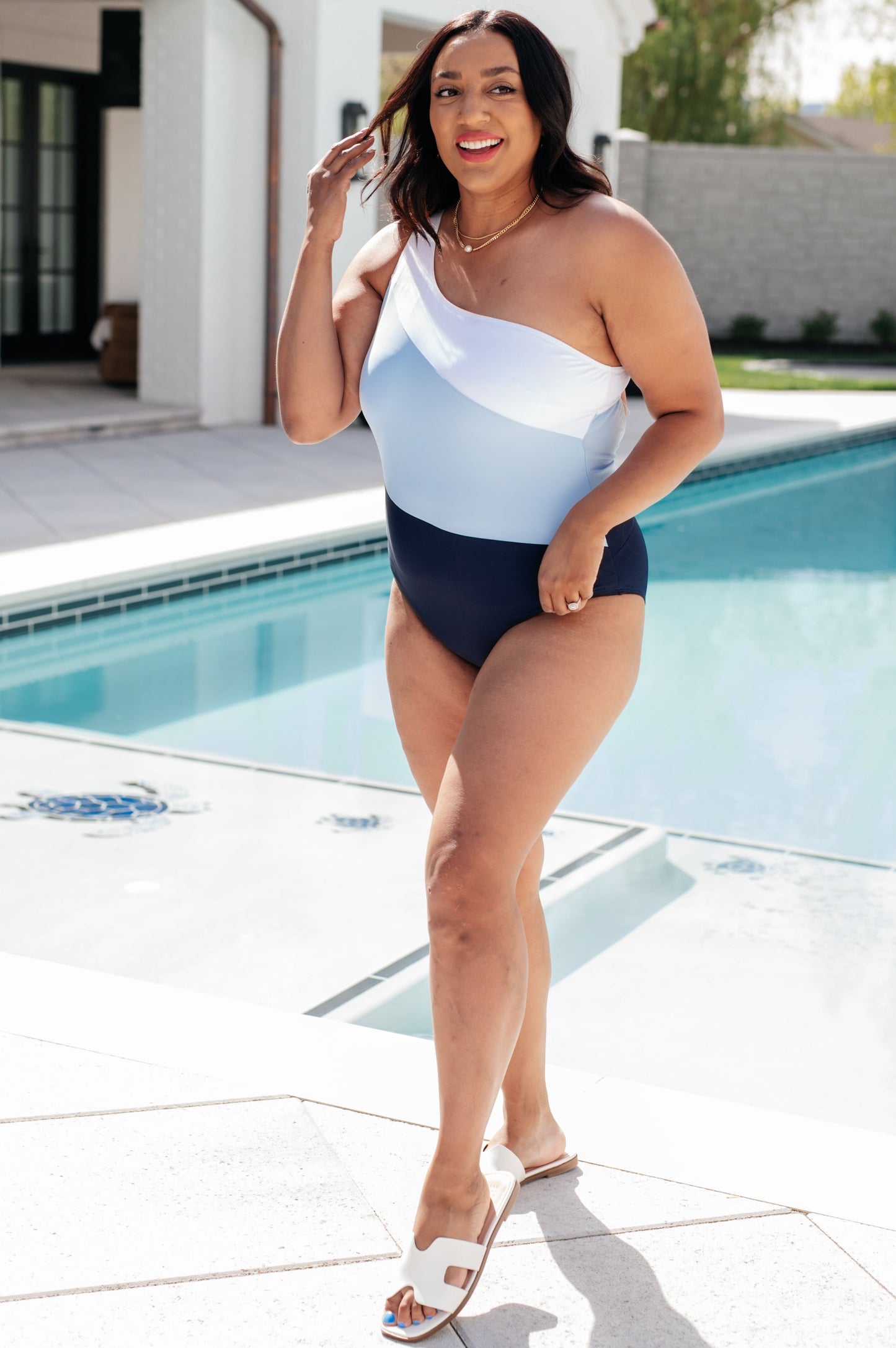 Dominica Color Block Asymmetrical Swimsuit in blue featuring a one-shoulder design, back cutout detail, removable cups, and an elastic underband for support.