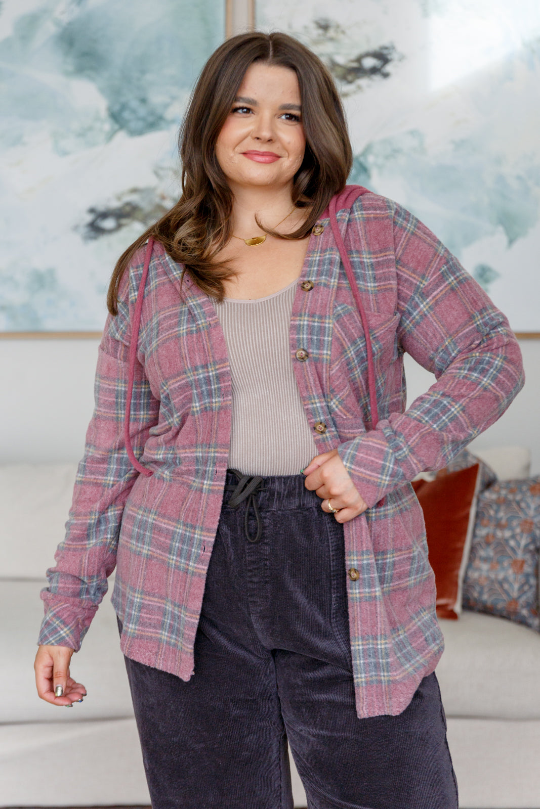 Women's Hooded Shacket in mauve plaid, featuring brushed plaid hacci fabric, hooded neckline, patch pocket, button front closure, and functional drawstring for a secure fit.