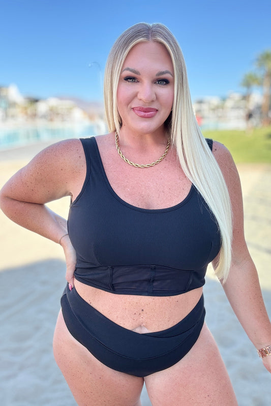 Plus size model wearing Down the Block Two Piece Swimsuit black ribbed bikini set.