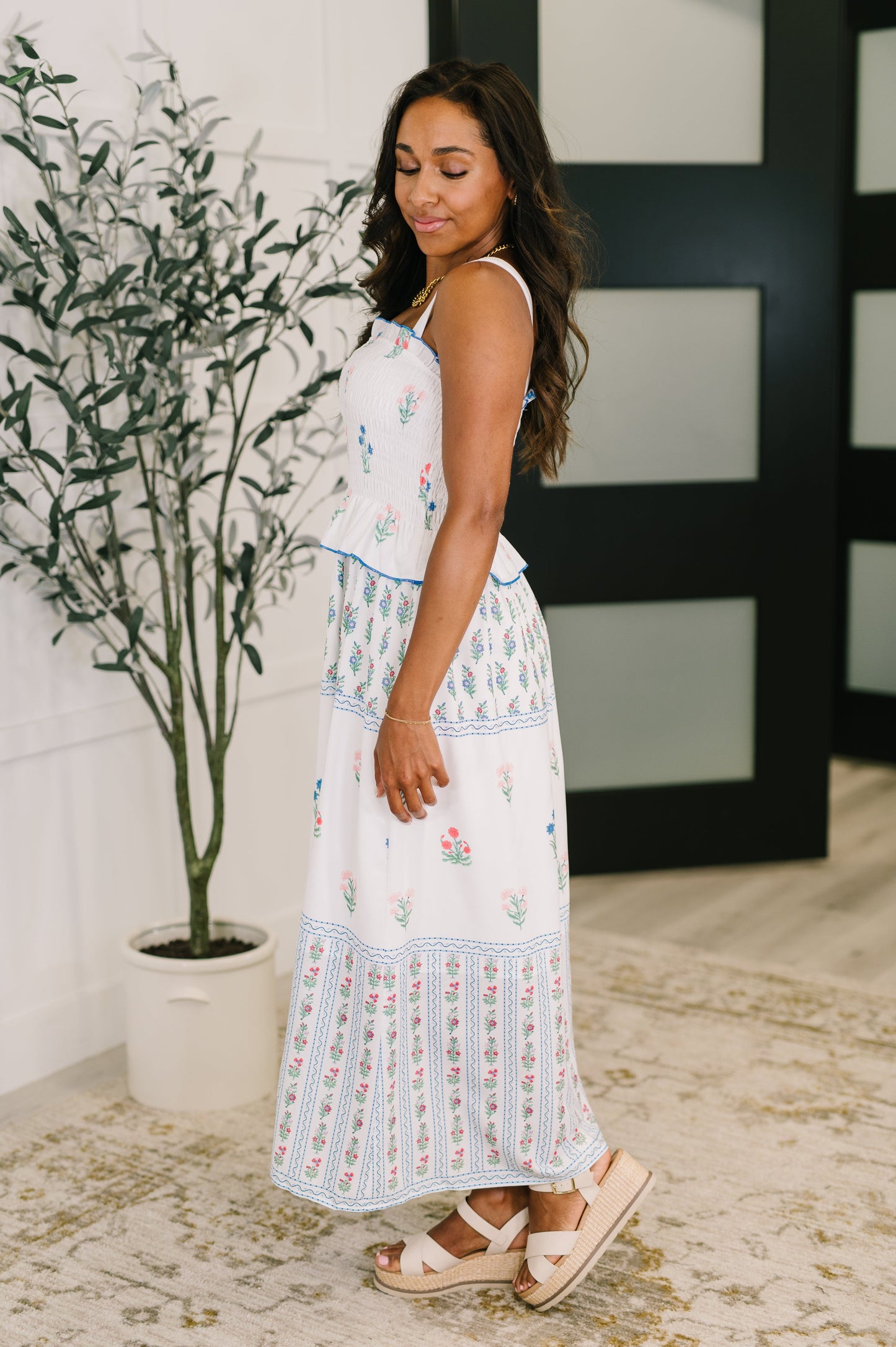 Side view of Maisy Floral Midi Dress with breezy silhouette and delicate ruffle details for a feminine summer look.
