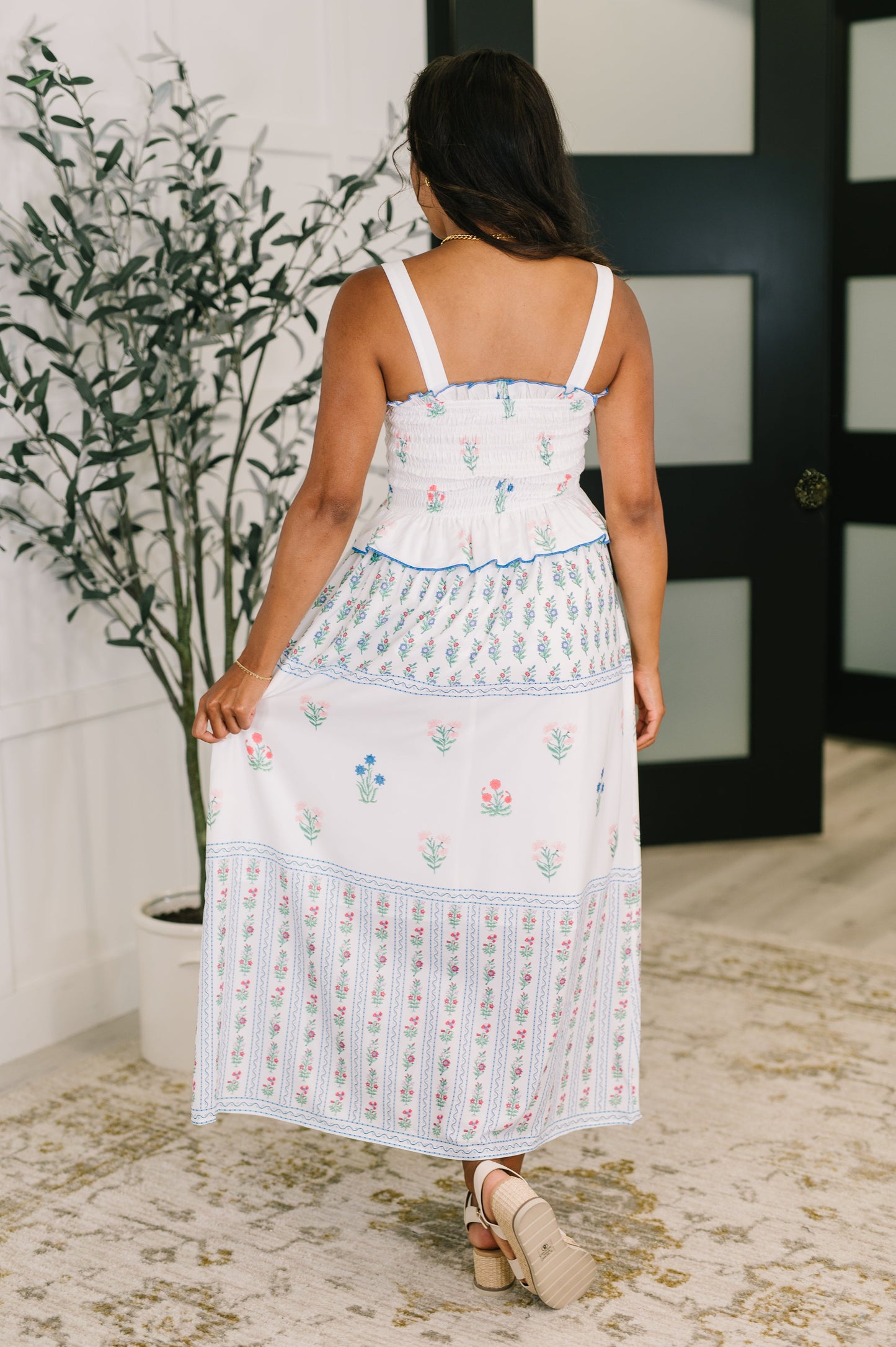 Back view of Maisy Floral Midi Dress featuring smocked bodice, ruffled trim accents, and a breezy feminine silhouette.