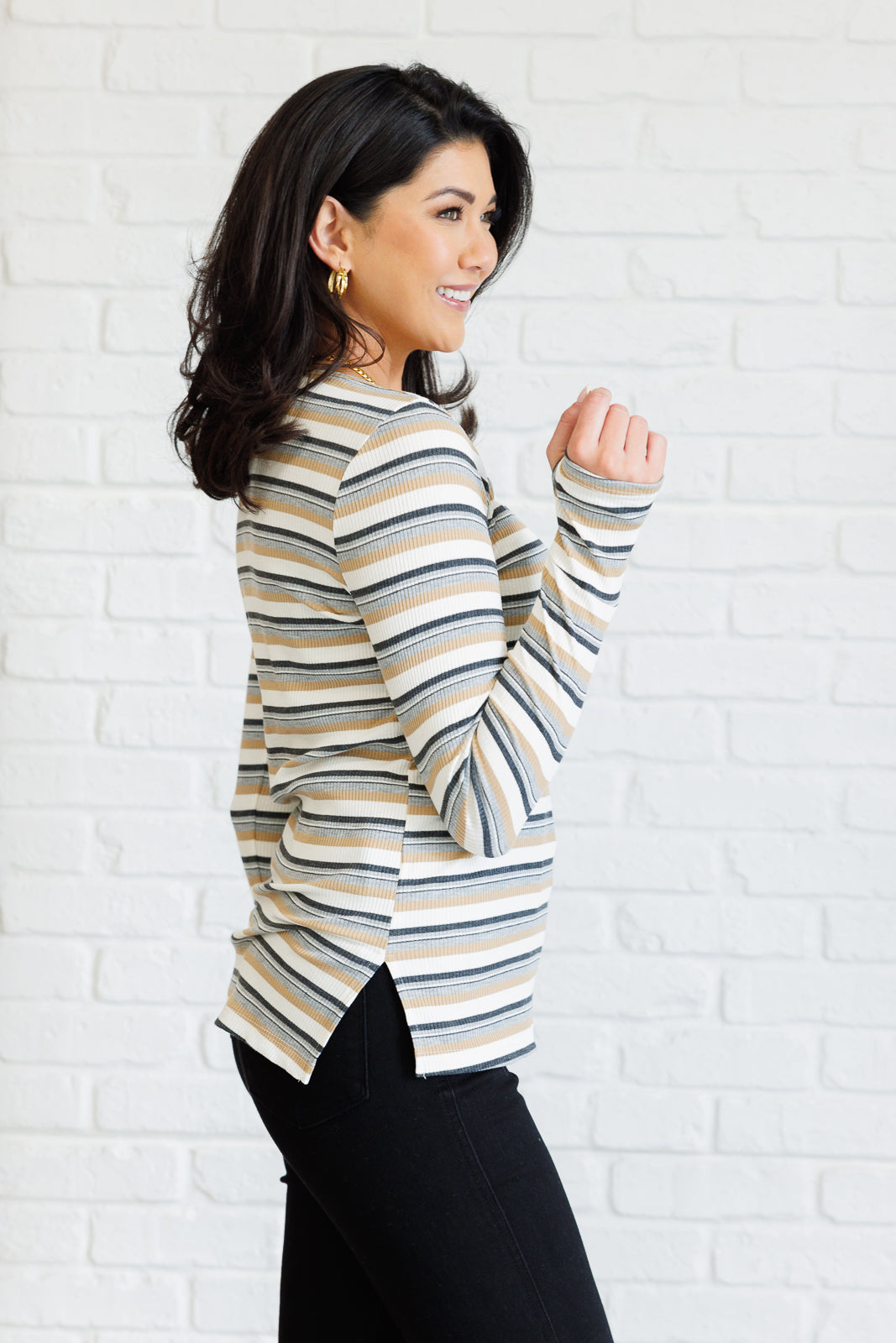 Side view of Xavia Striped Top with round neckline, ribbed knit striped fabric, and side slit detail.