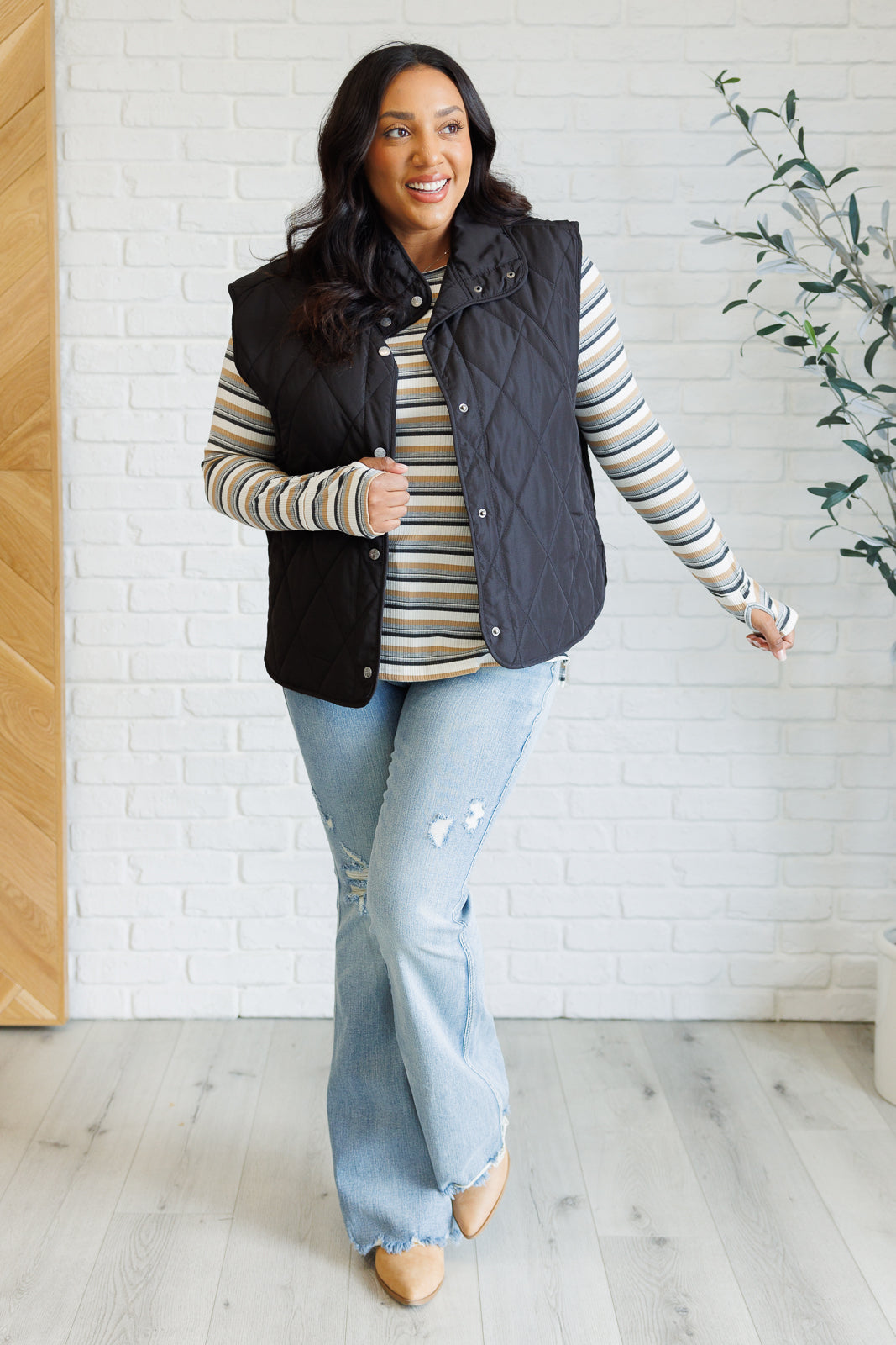 Plus size full body view of Xavia Striped Top styled casually with jeans and side slit detail.