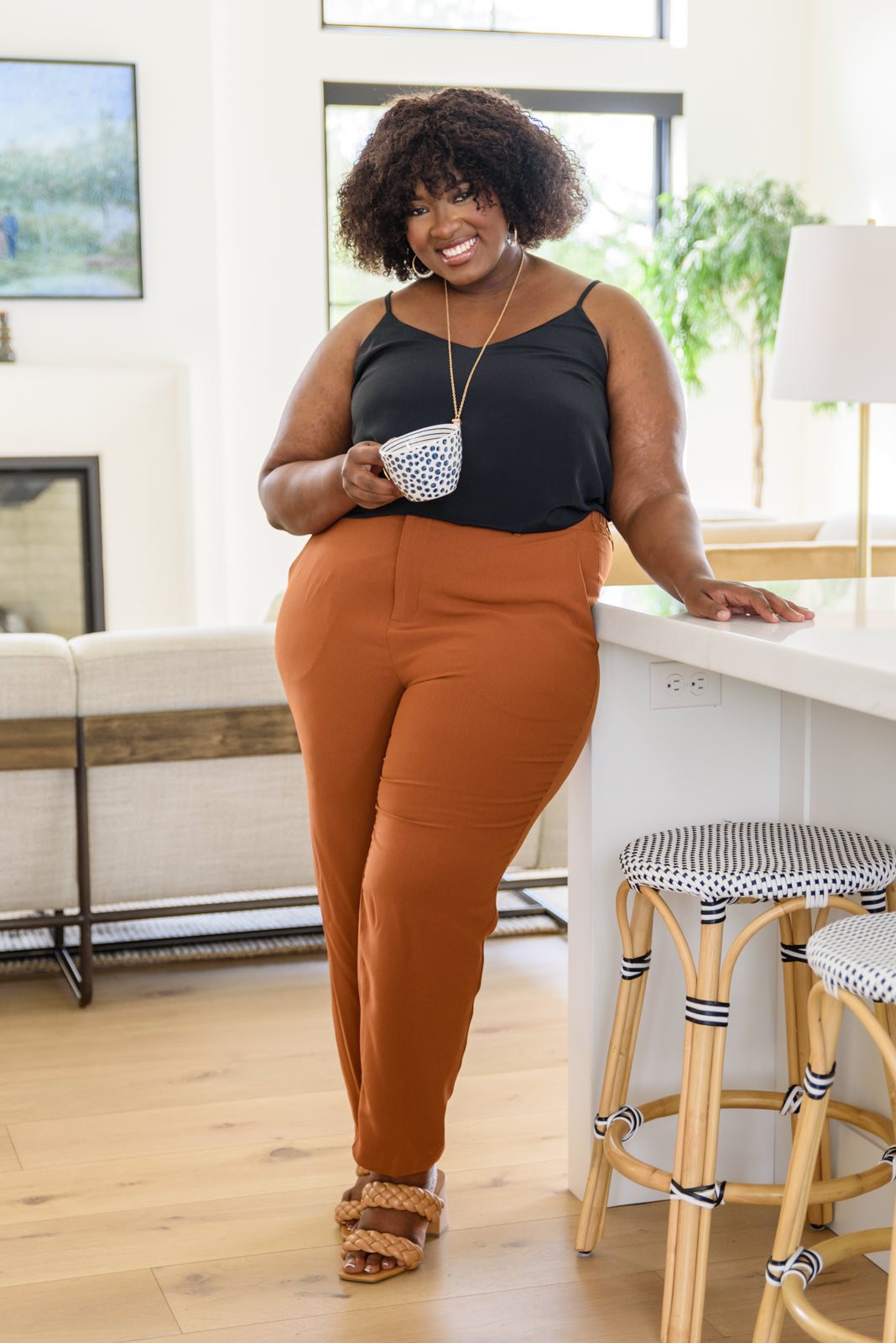 Plus size black v-neck tank top with adjustable spaghetti straps and flowy fit – perfect under blazers or cardigans.