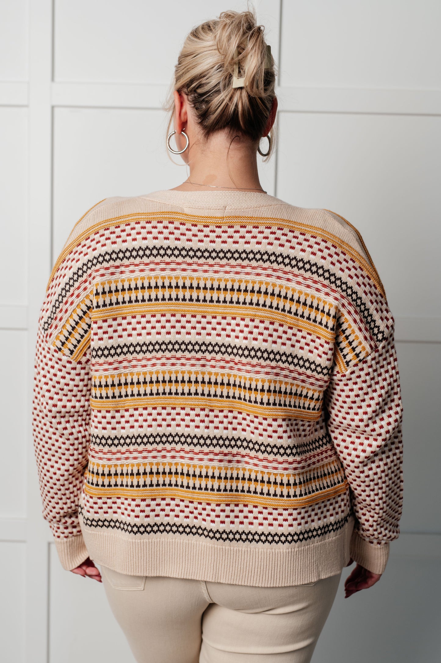 Back view of plus size Ellie Striped Cardigan in cream with mustard, rust, and brown stripes, ribbed hemline.