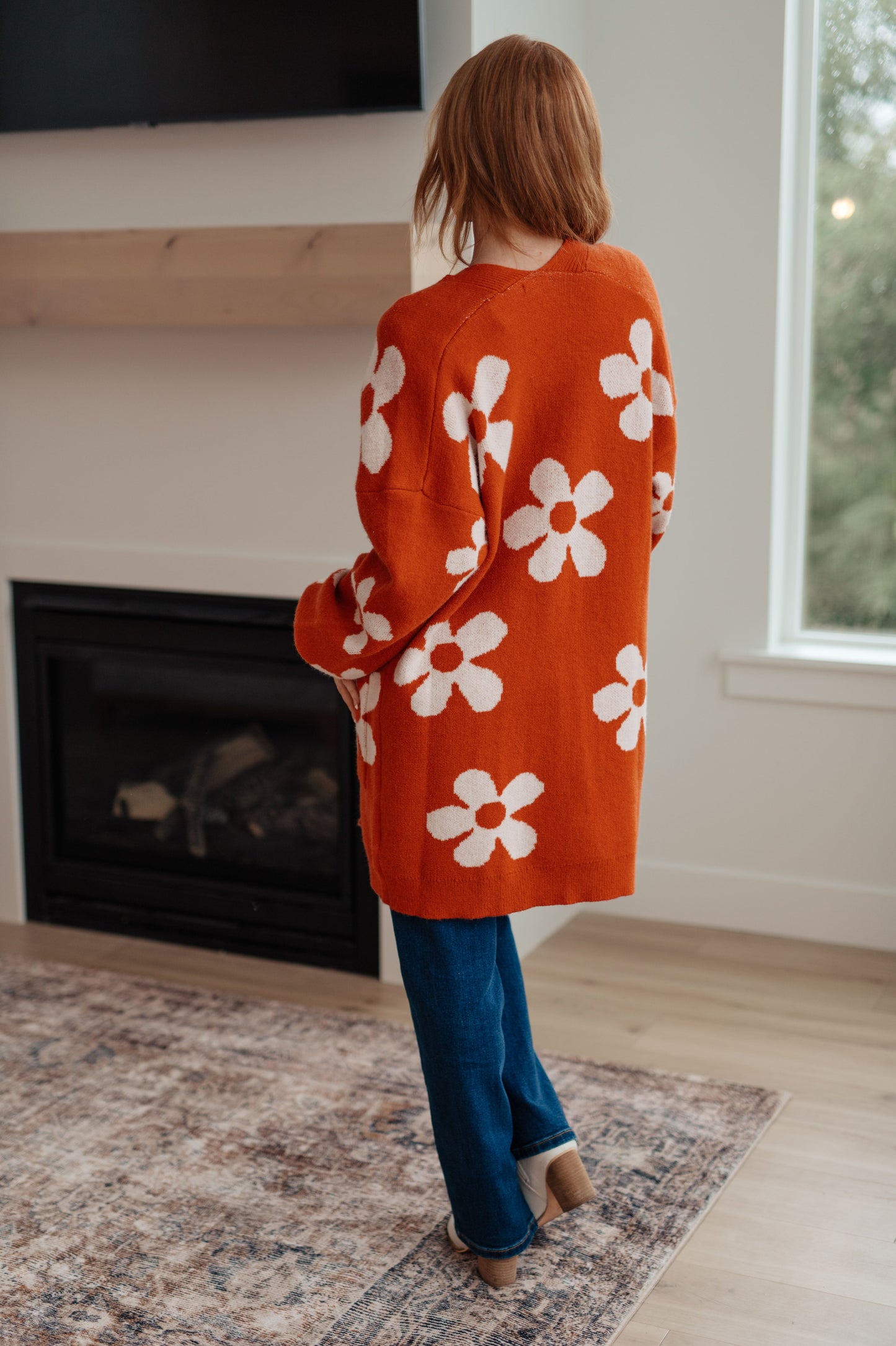 Back view of Edna Floral Cardigan featuring bold floral print on soft sweater knit fabric.