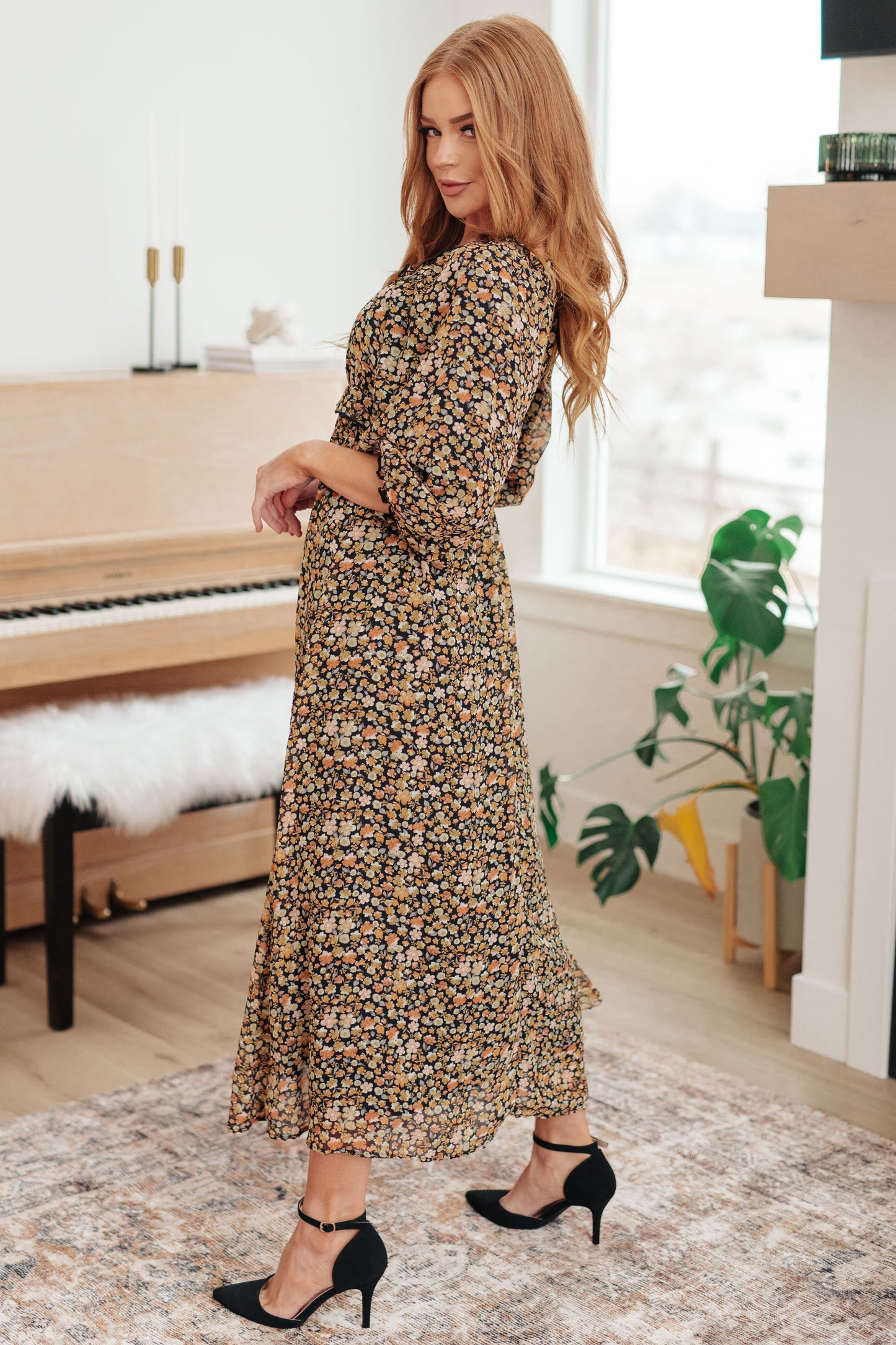 Black/orange floral maxi dress with square neckline and ruffle details, side view.