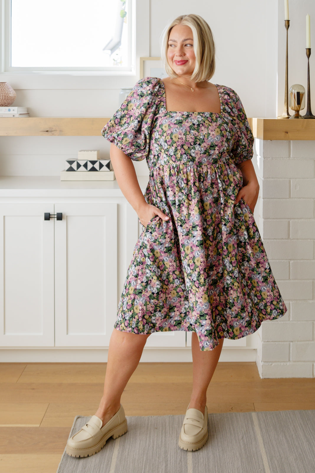 Plus size full body view of model wearing Skyla Floral Dress in pink floral with square neckline.