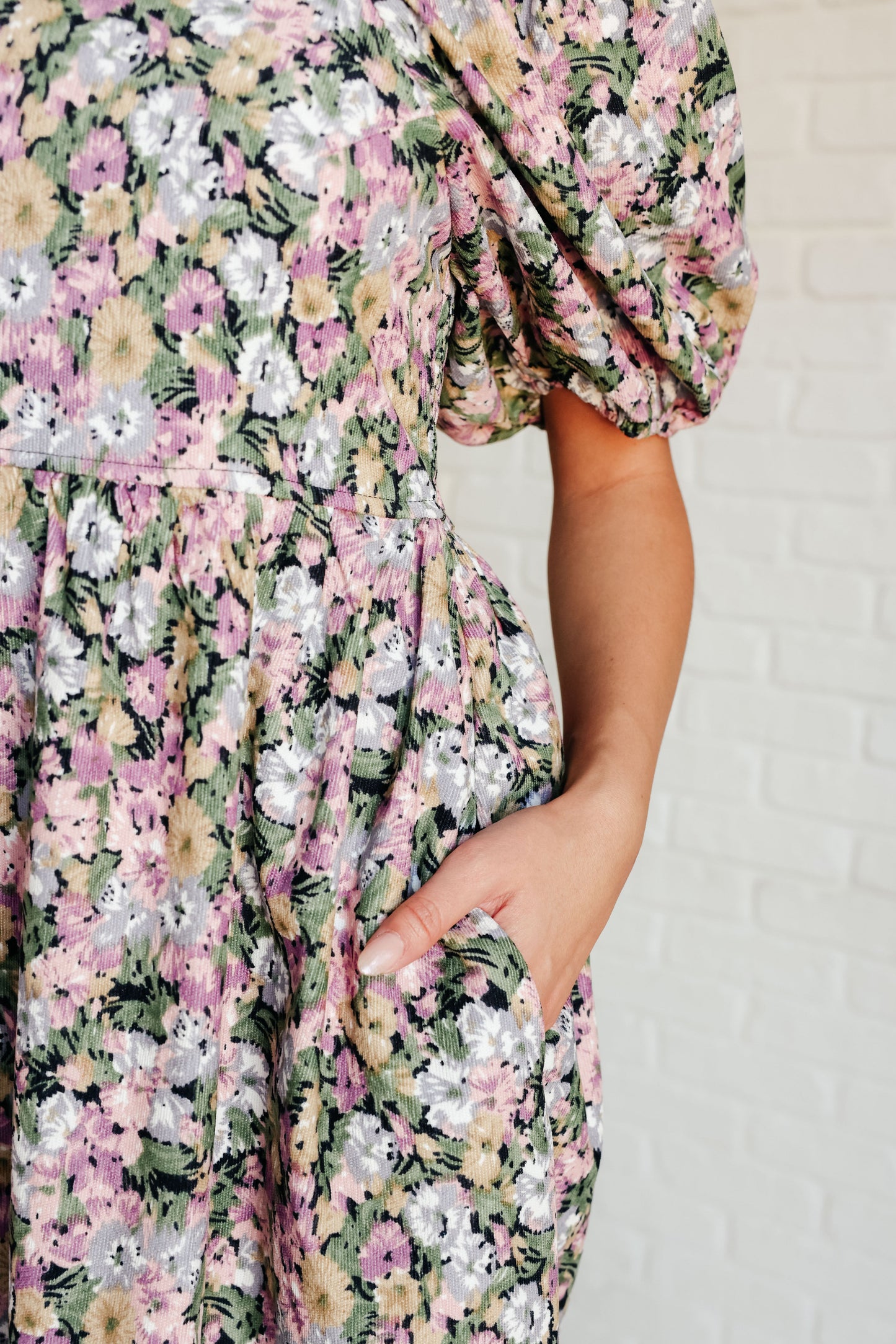 Close-up of Skyla Floral Dress fabric with pink, green, and lilac floral print and hidden pocket.