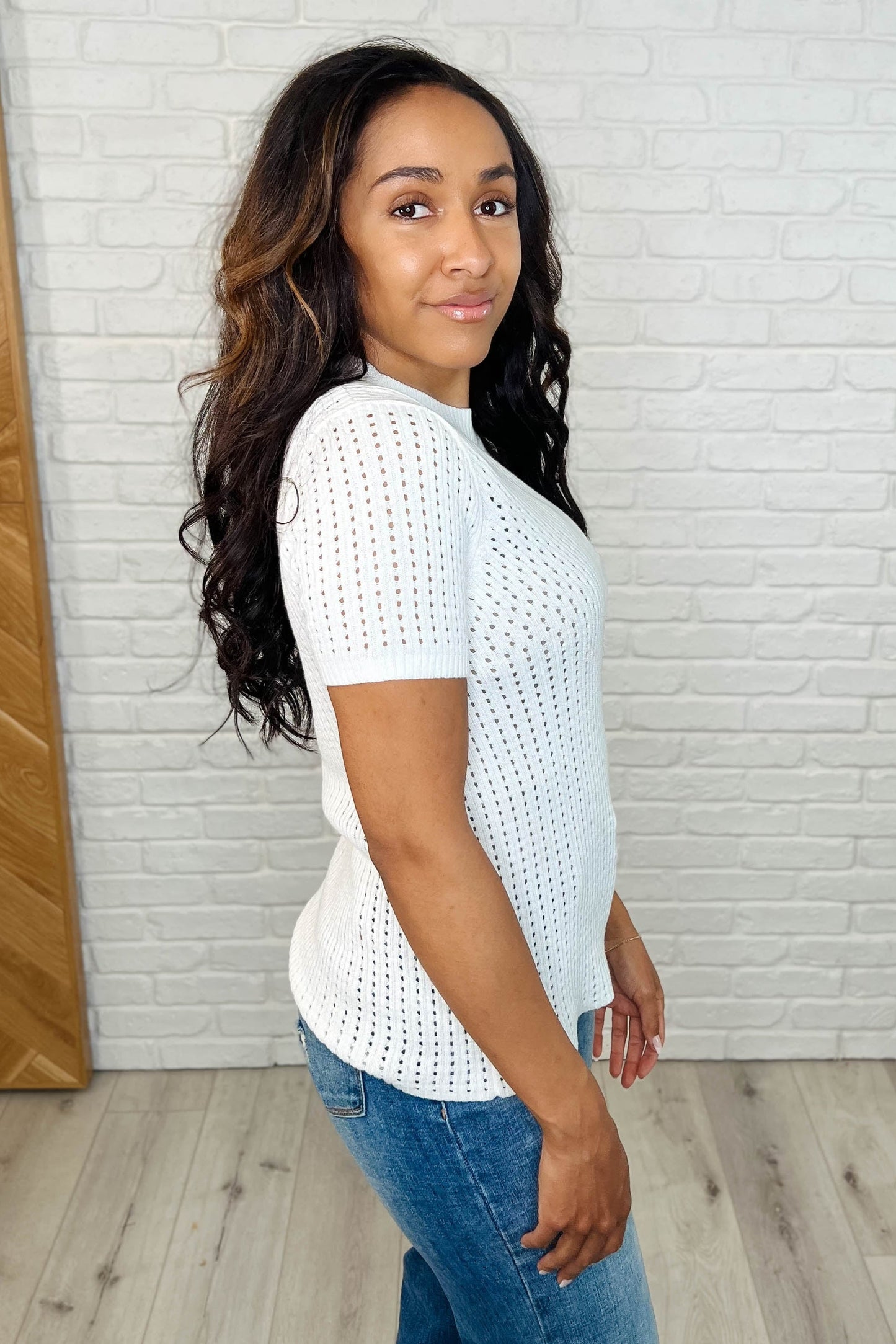 Side angle showing slim fit of Felicia tee with soft open weave sweater knit and high-stretch comfort.