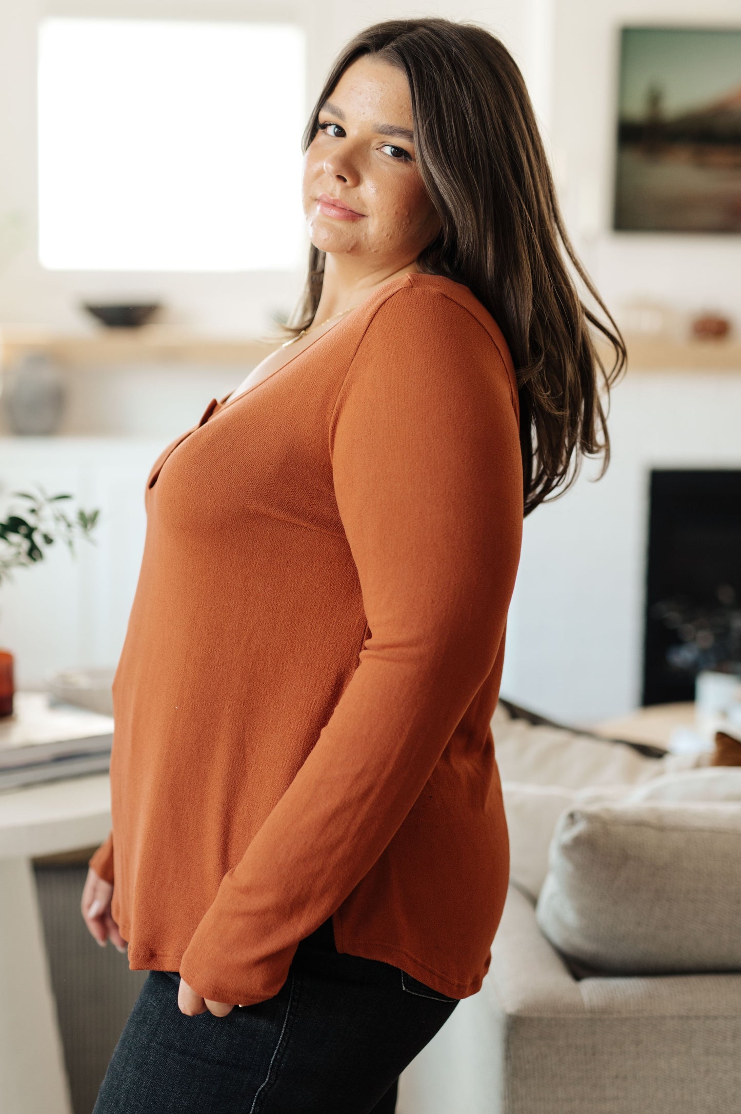 Side profile of plus size model in Dacia Scoop Neck Henley Top, pumpkin knit with relaxed fit