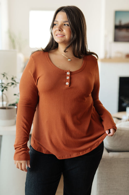 Plus size model in Dacia Scoop Neck Henley Top, pumpkin color with scoop neckline and relaxed fit