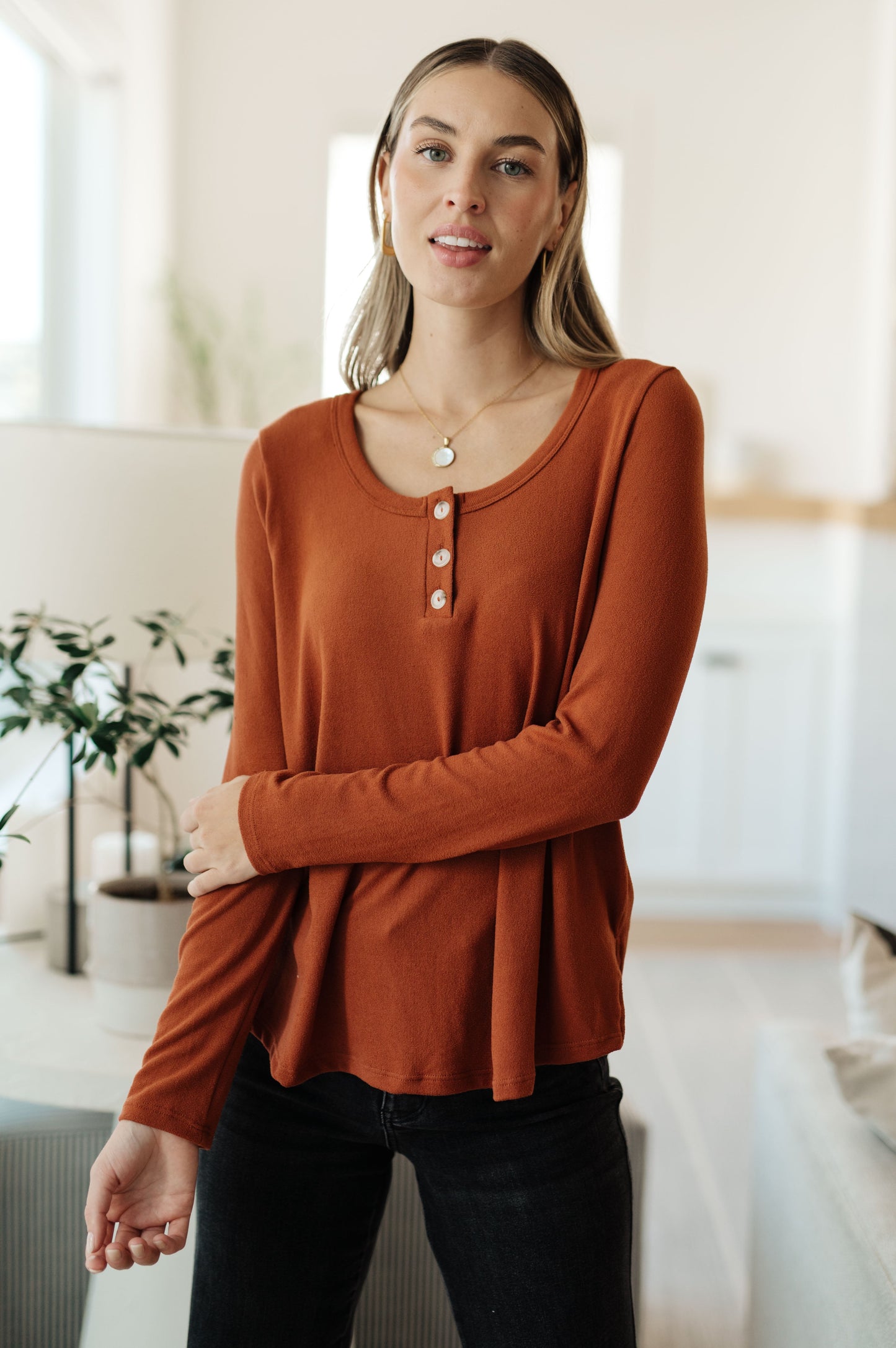 Model wearing Dacia Pumpkin Scoop Neck Top with button-up henley design in brushed knit fabric