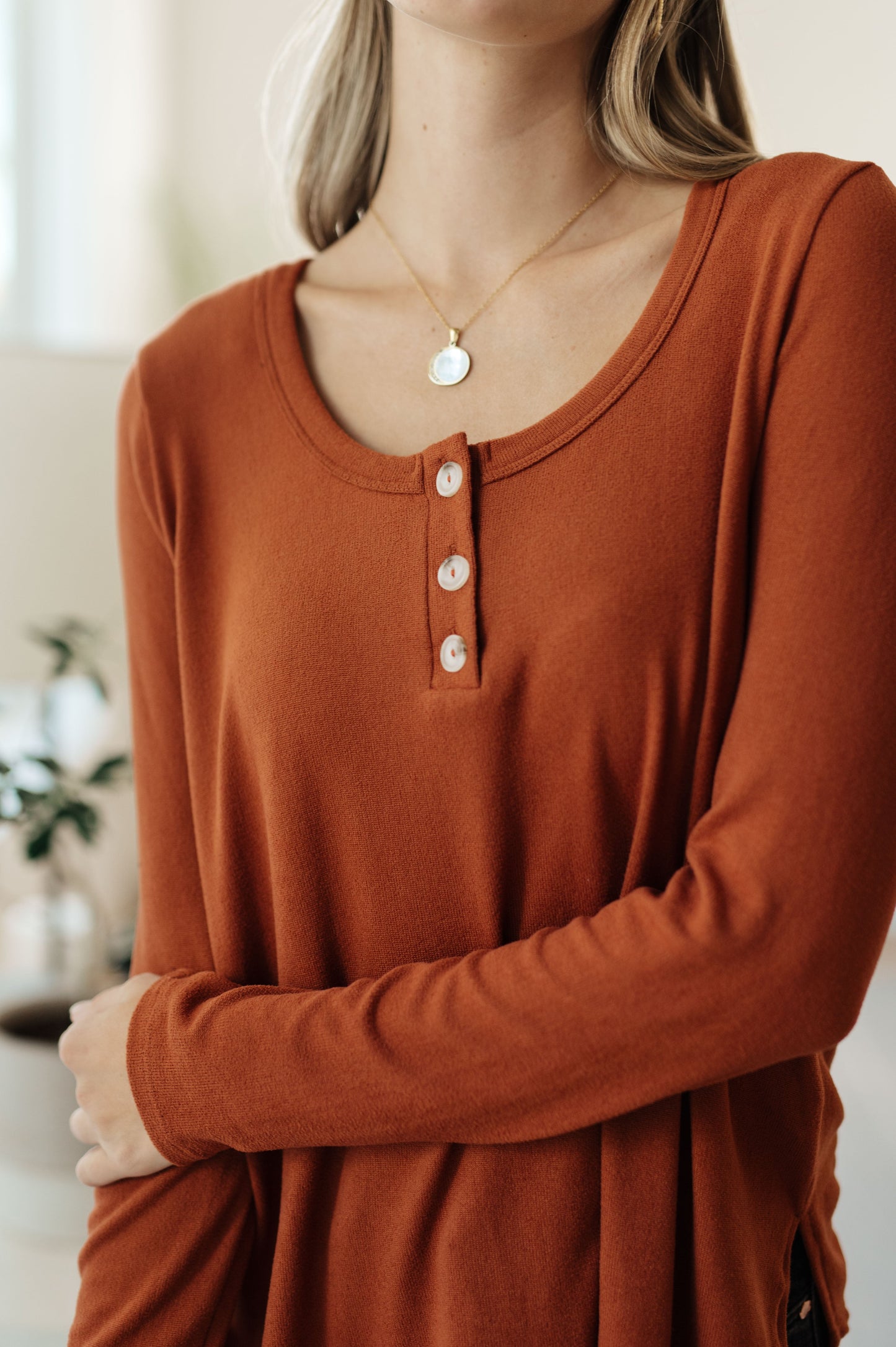 Close-up of Dacia Scoop Neck Henley Top showing brushed knit fabric, scoop neckline, and button detail
