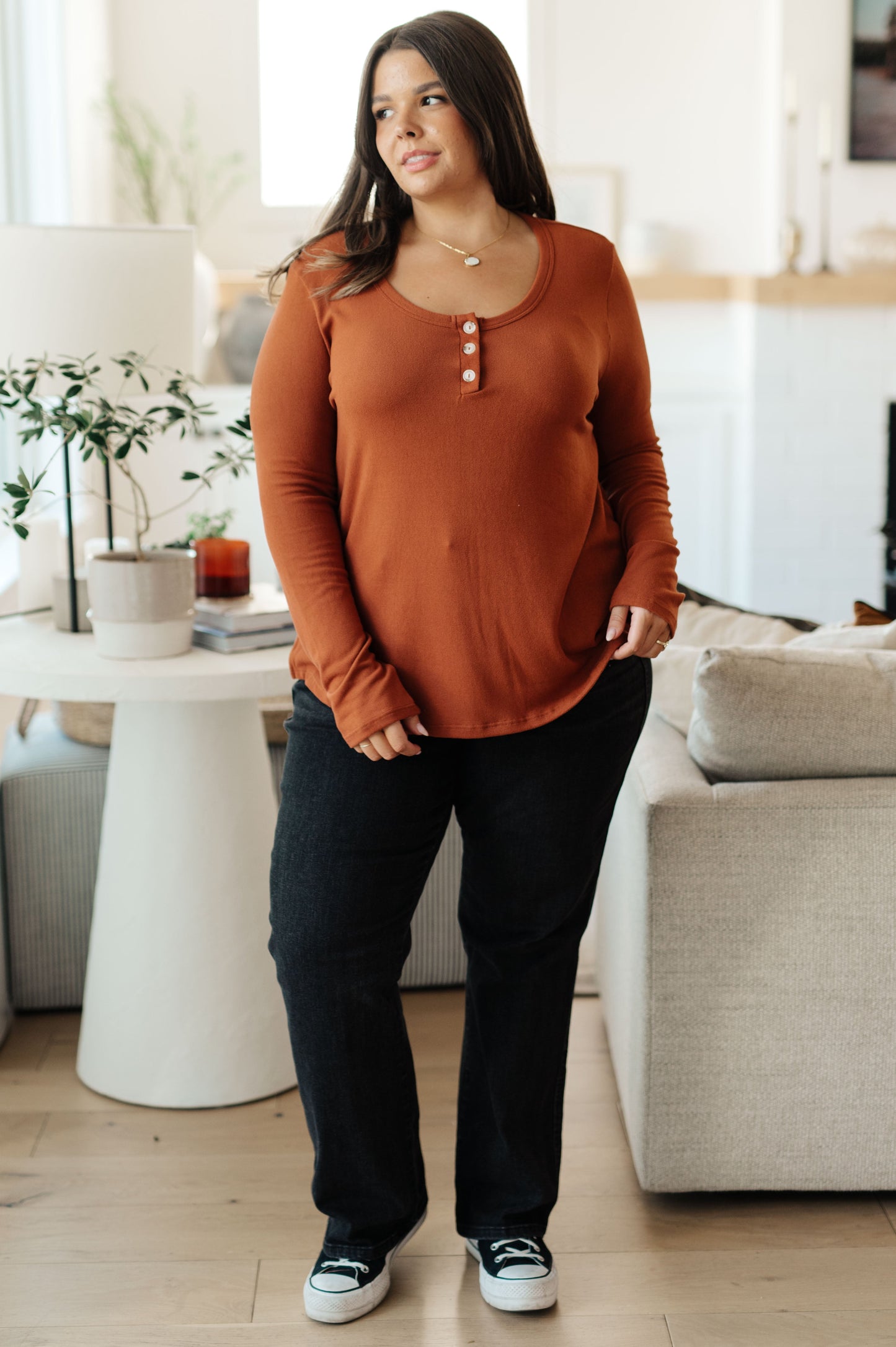 Plus size model styled in Dacia Pumpkin Scoop Neck Top, full body view with casual jeans