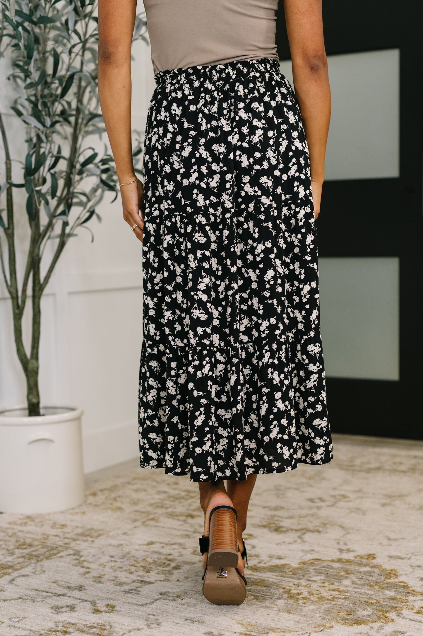 Back view of Virginia Floral Skirt in black floral print showing drape and length.