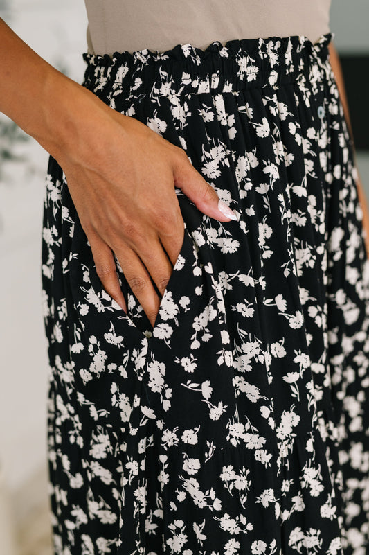 Close-up of Virginia Floral Skirt showing elastic waistband and floral button details.