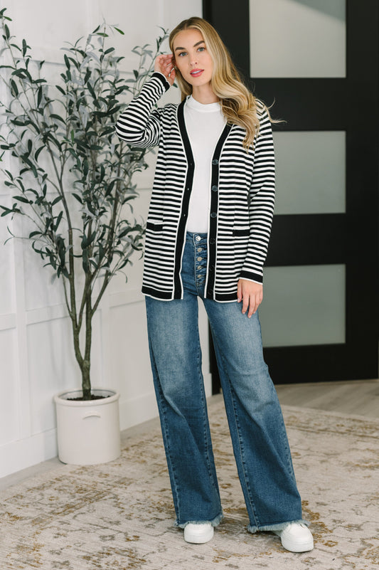 Model wearing Finn Striped Cardigan with pockets, styled with jeans for casual comfort.