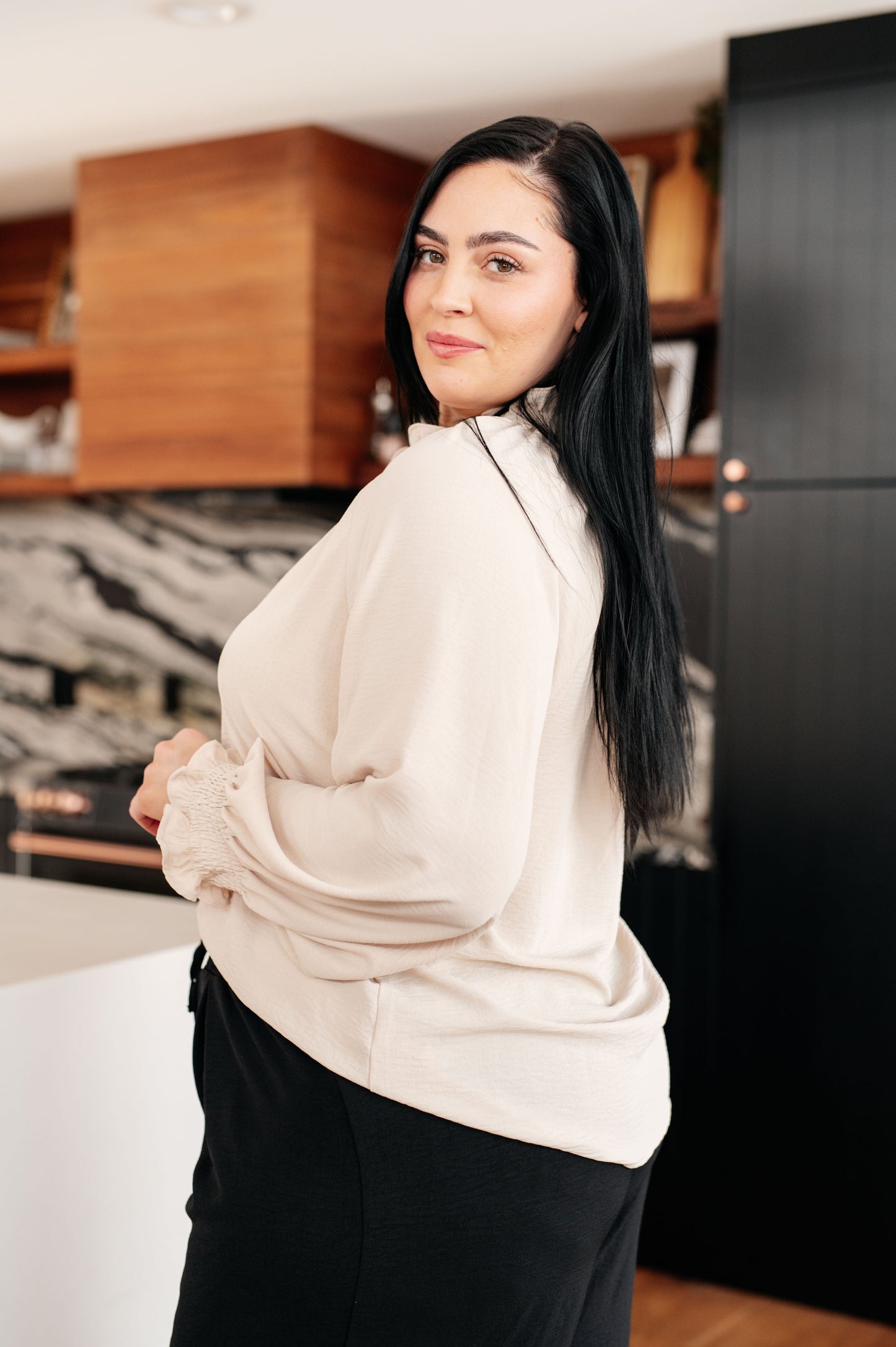 Side view of plus size Florence Button Up Blouse cream with long sleeves.