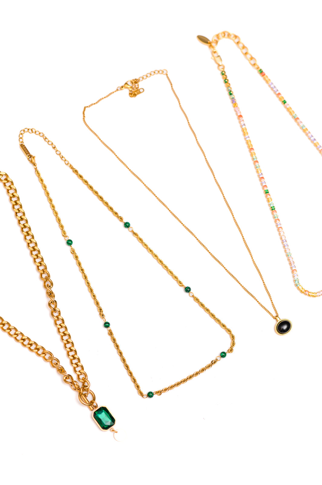 Flat lay of For the Glory Jewelry Set with four gold and turquoise necklaces displayed together.
