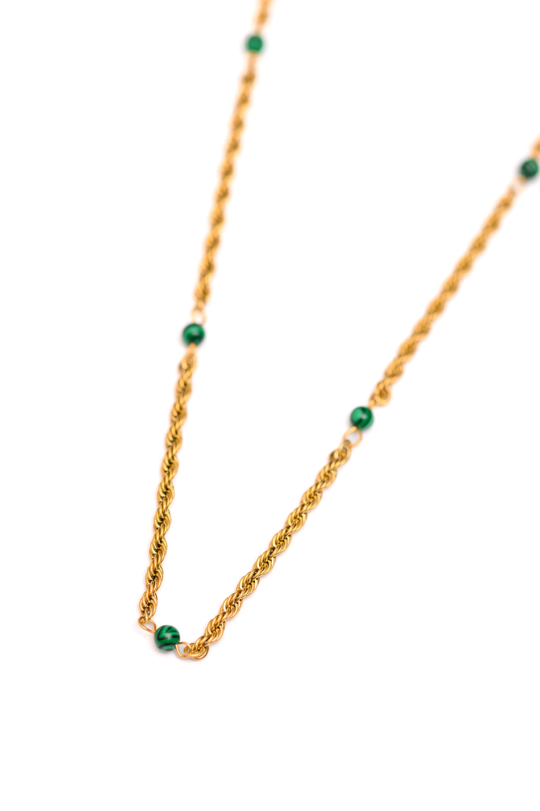 Flat lay of Drops of Turquoise gold necklace with delicate turquoise accents.