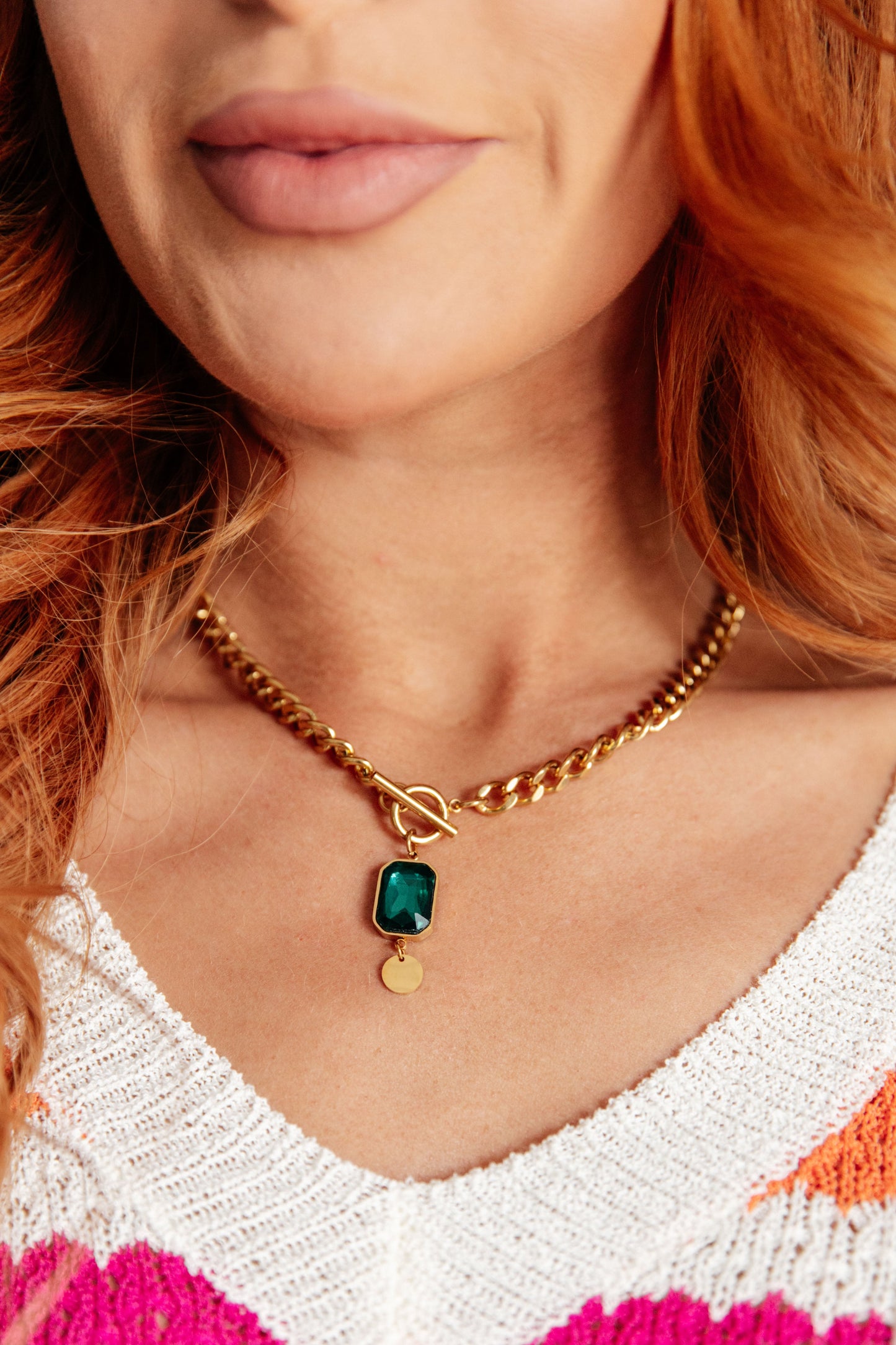 Model wearing Center of It All pendant necklace, gold with simple circular charm.