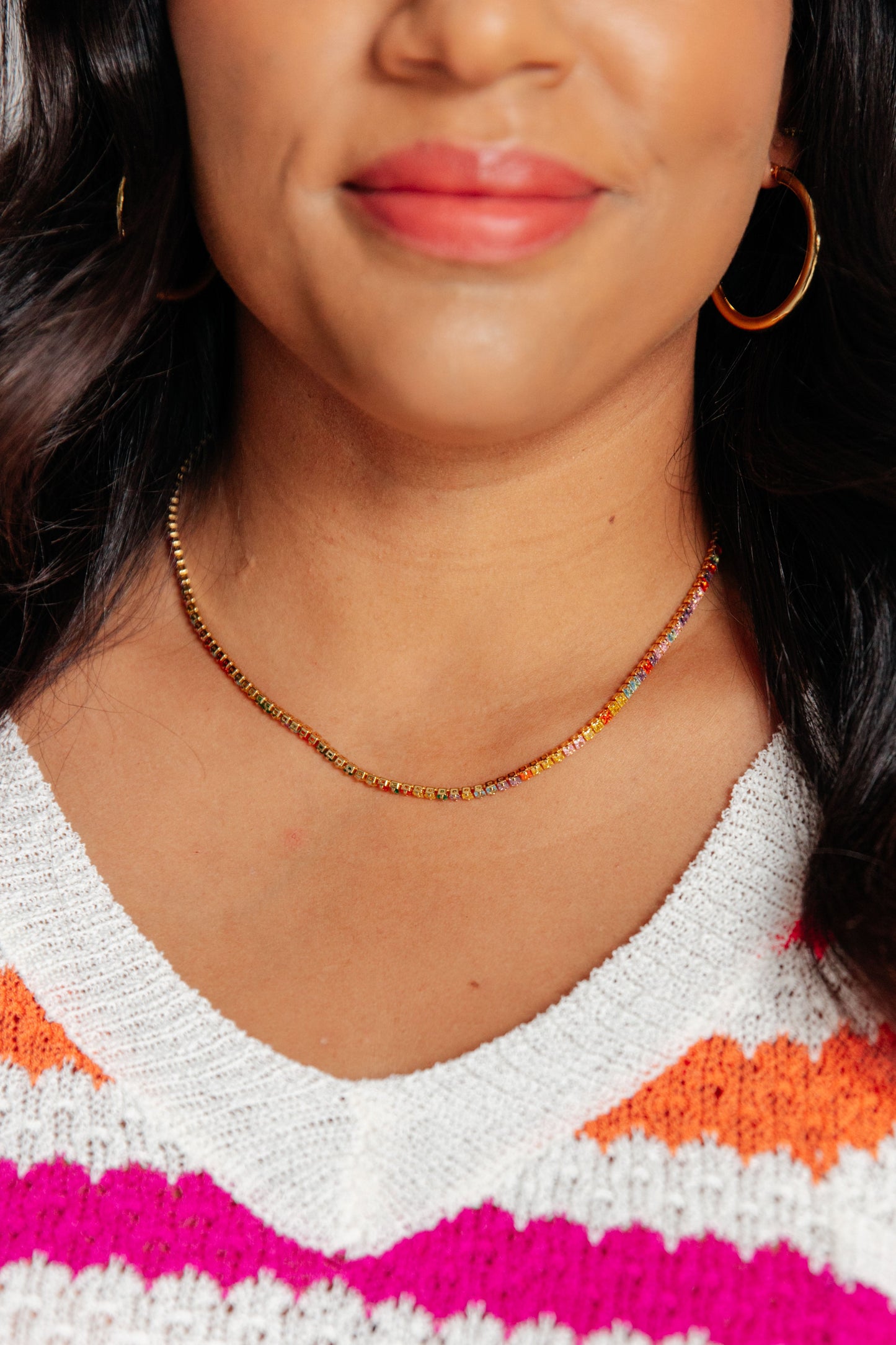 Model wearing Emerald Chain Necklace, gold chain with emerald green charm.