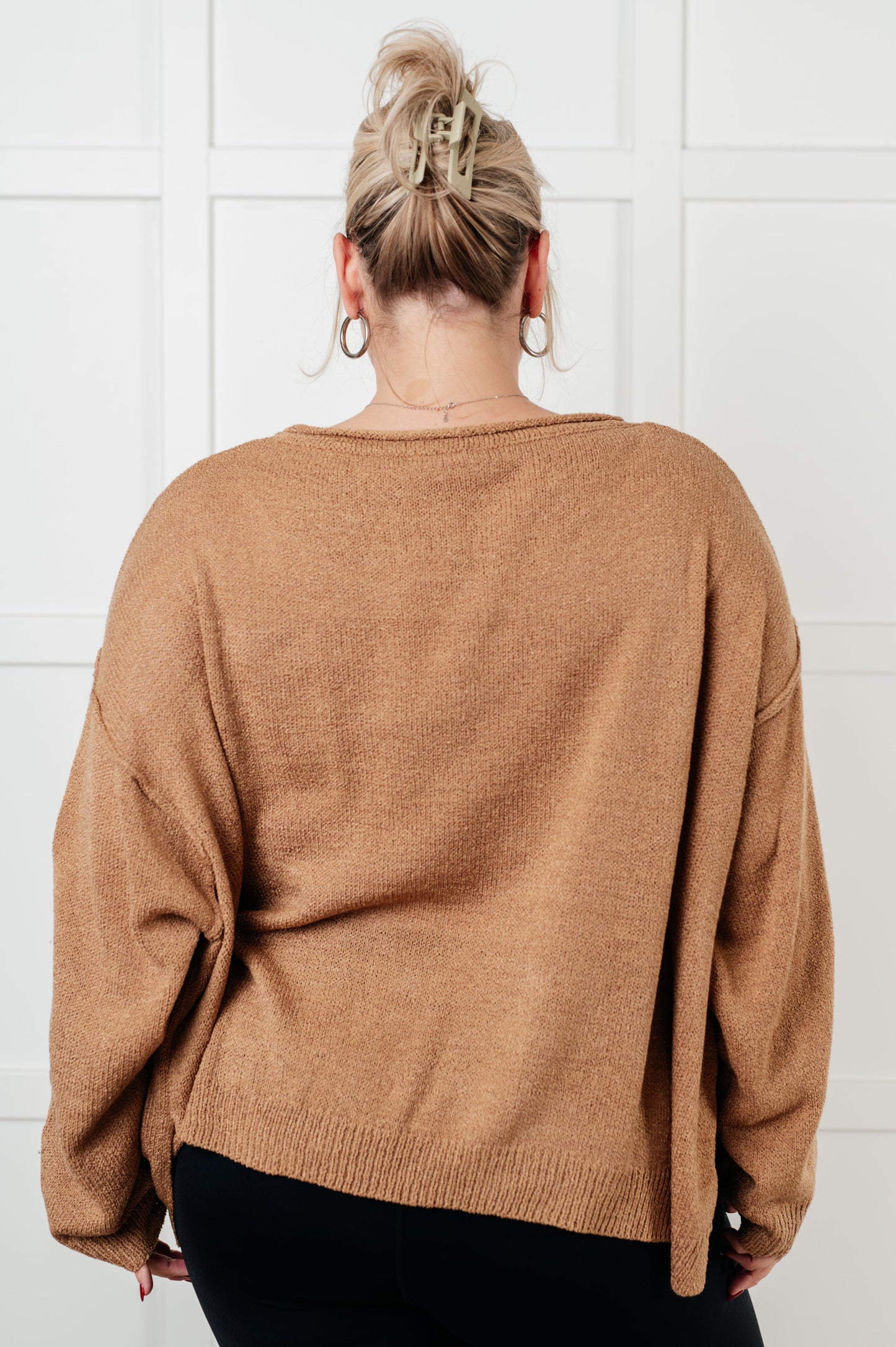 Back view of plus size Gene Boatneck Sweater in tan, oversized silhouette with side slits.