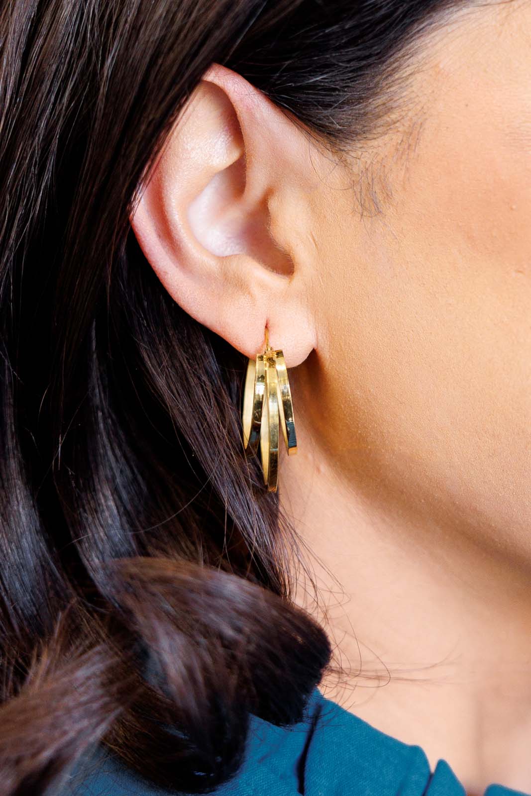 Close-up of model wearing Get In Line Hoops with 18K gold-plated double-layer detail.