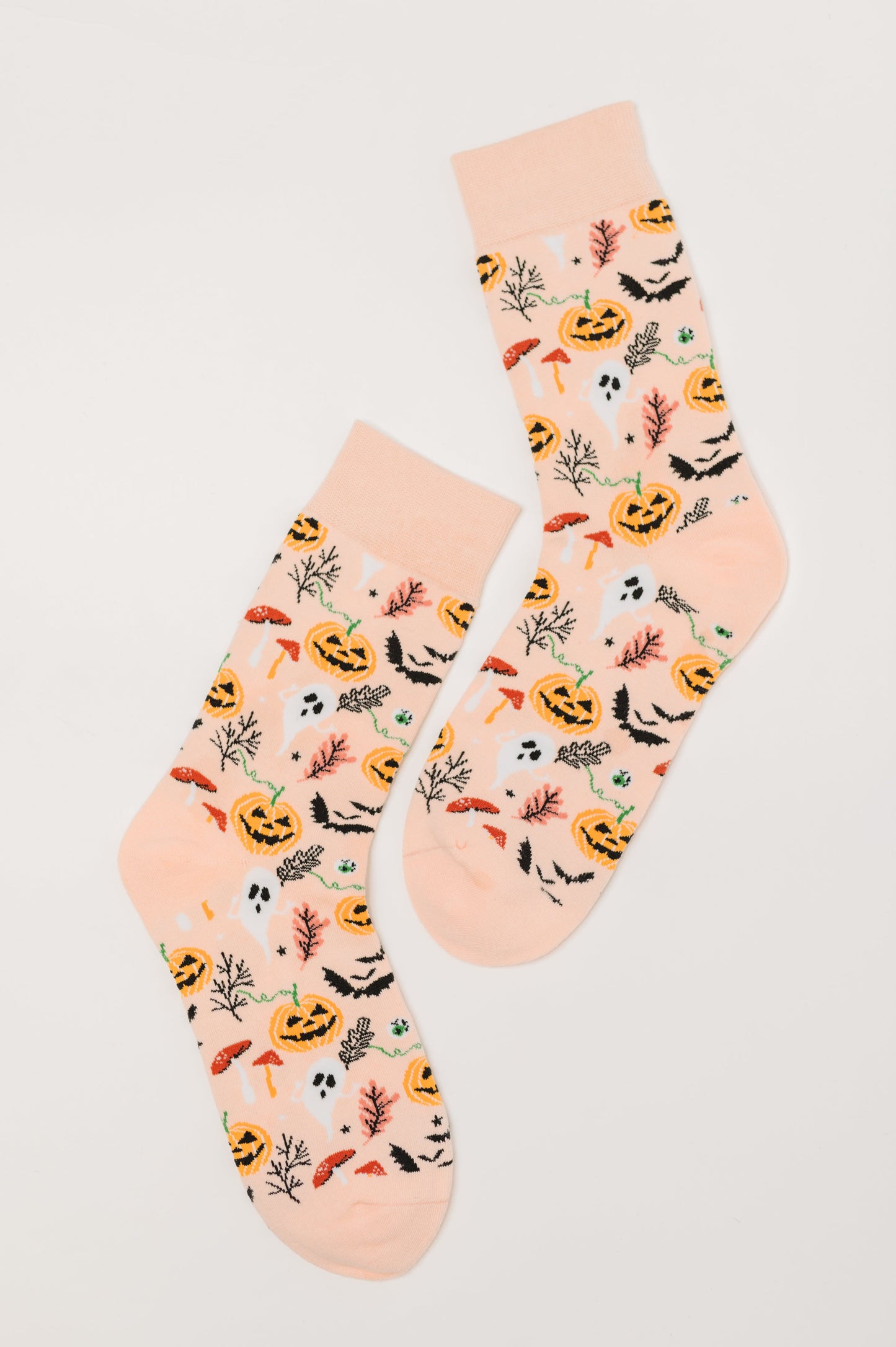 Flat lay of Ghouls Night In Quarter Socks in peach with spooky graphics