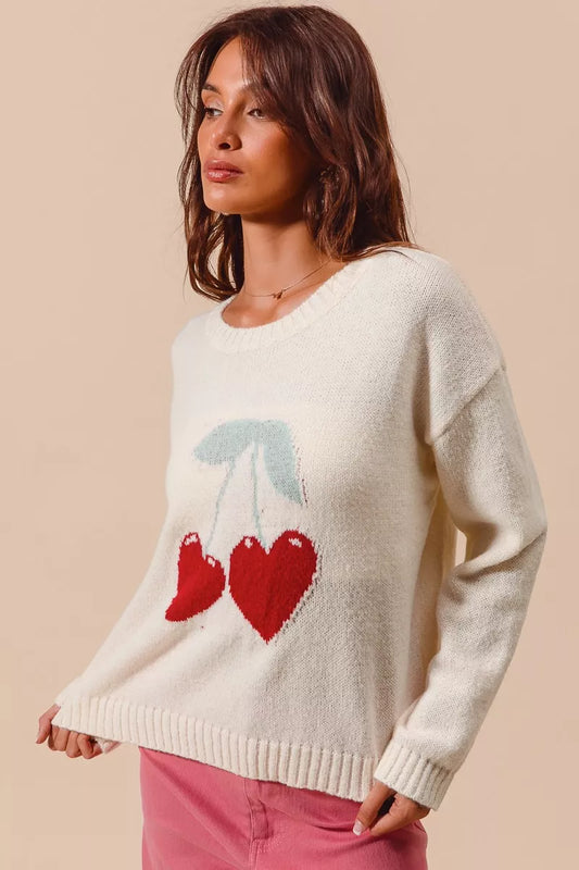 Side angle of Gina Heart Cherry Sweater highlighting ribbed knit texture.