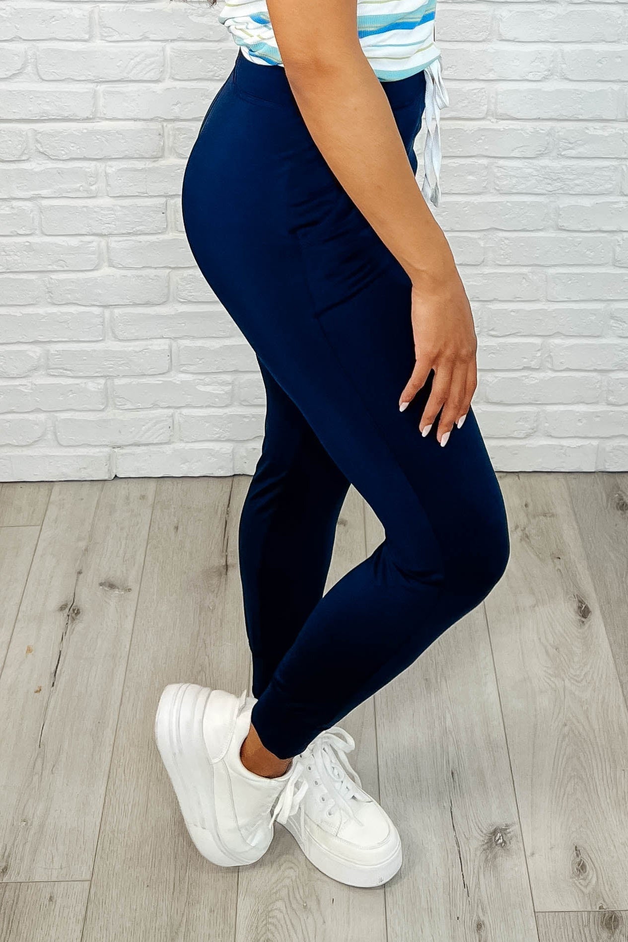 Side view of Genna joggers showing functional pocket and relaxed athletic fit.