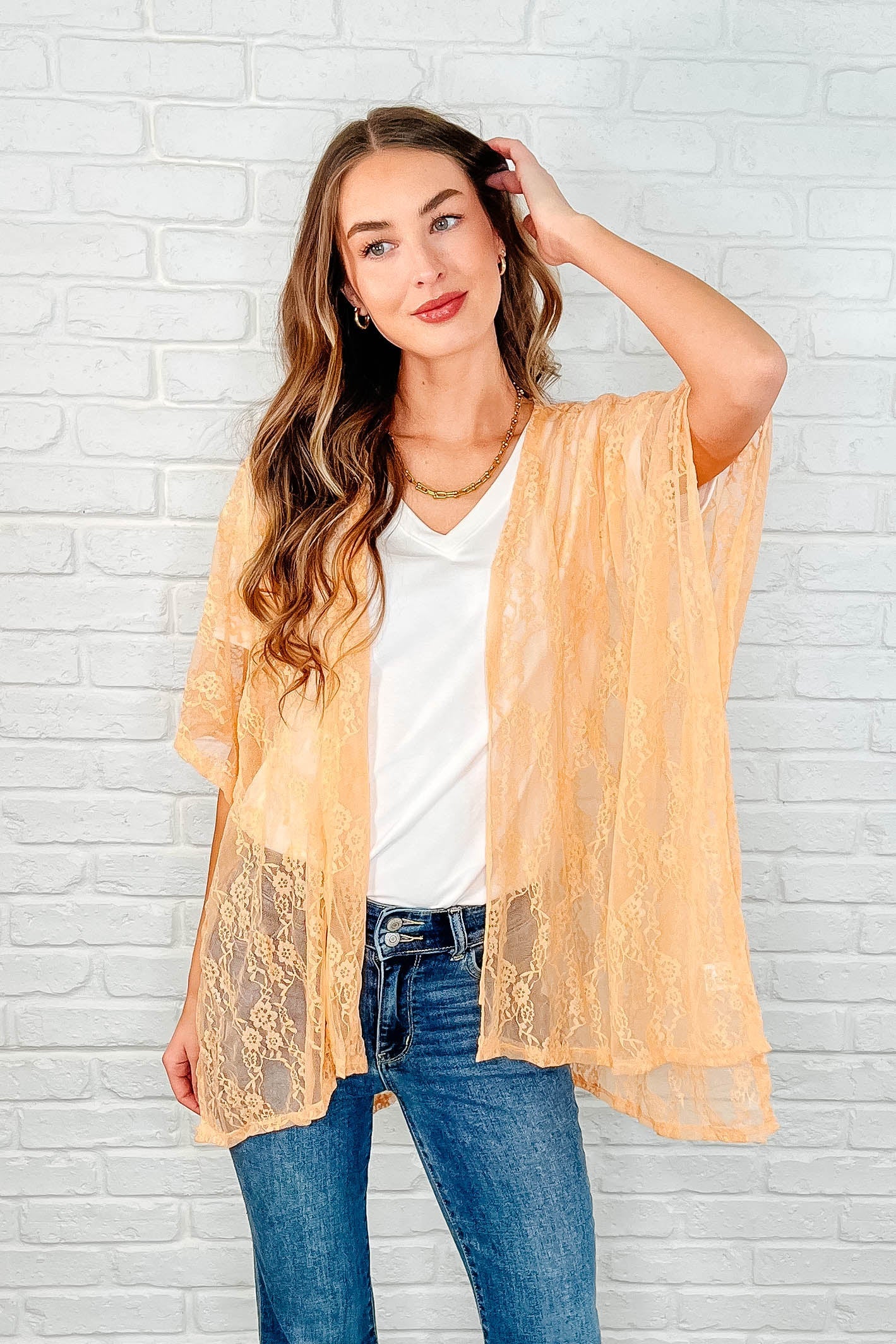 Trendy Dakota Lace Kimono in peach, made with stretch lace, featuring an open front, dolman half sleeves, and stylish side slits for added flair.