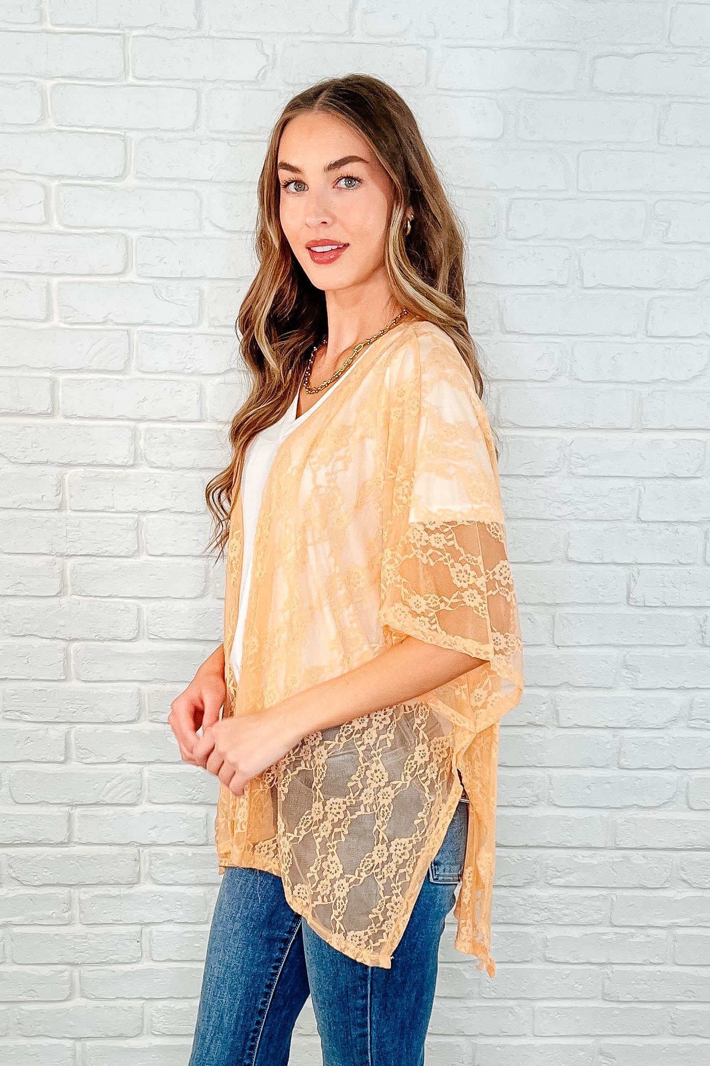 Dakota Lace Kimono in peach with a comfortable, stretchy lace fabric, open front, dolman sleeves, and side slits for a modern, relaxed vibe.