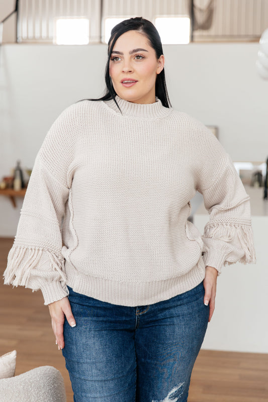 Plus size model wearing Haniya Fringe Detail Sweater in Bone with long balloon sleeves.