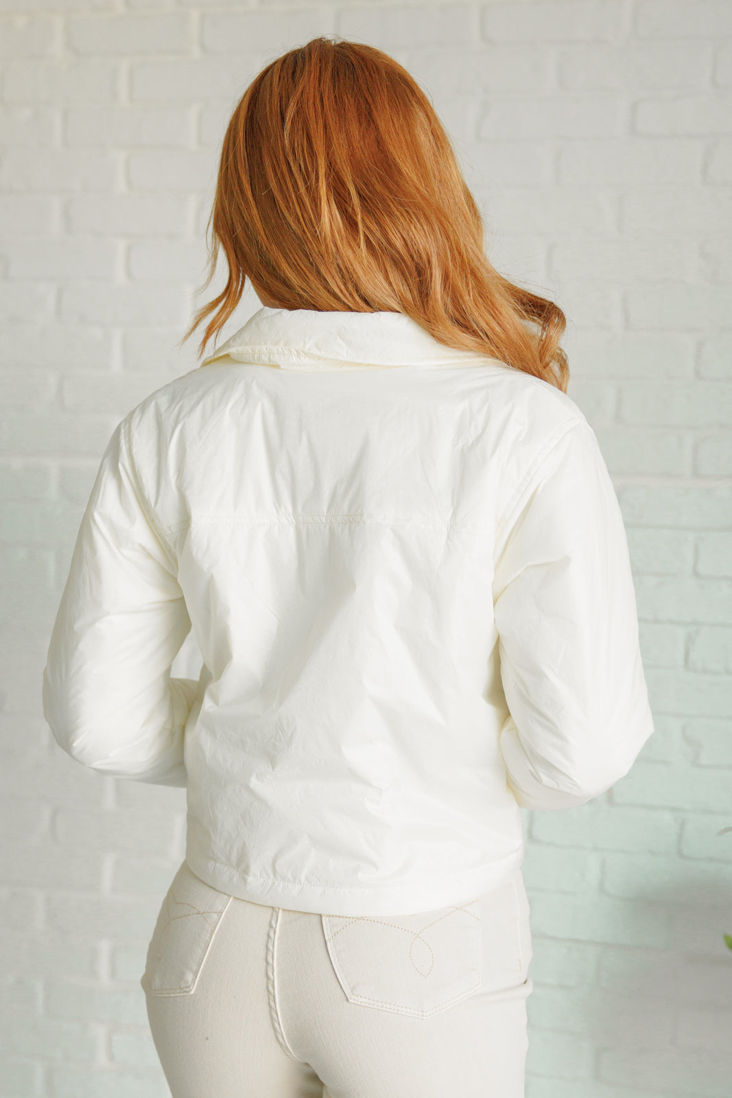Back view of model in bone Cali Lightweight Puffer Jacket showing lightweight texture.