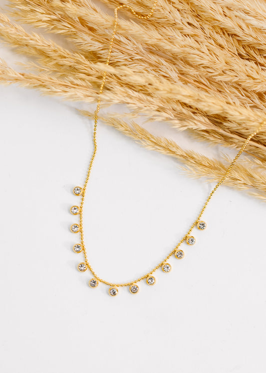 Close-up of Here to Charm Necklace showing sparkling clear zircon stones.