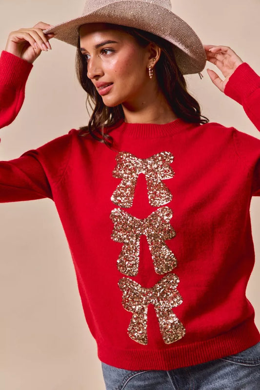 Front view of Hermione Christmas Sweater showing sparkly sequin bow design.