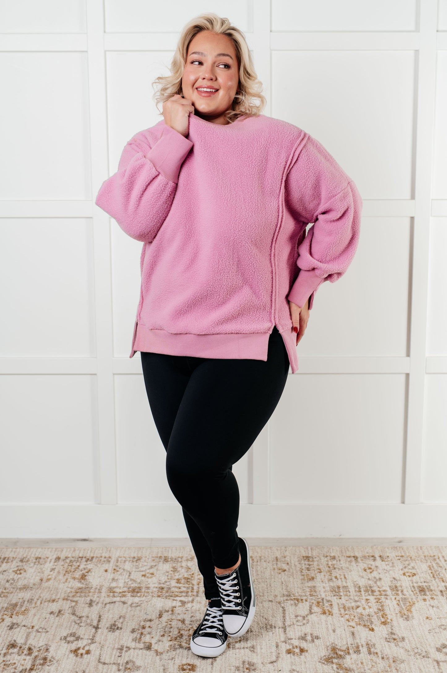 Plus size model full body in Danna Fleece Pullover, pink fleece with black leggings