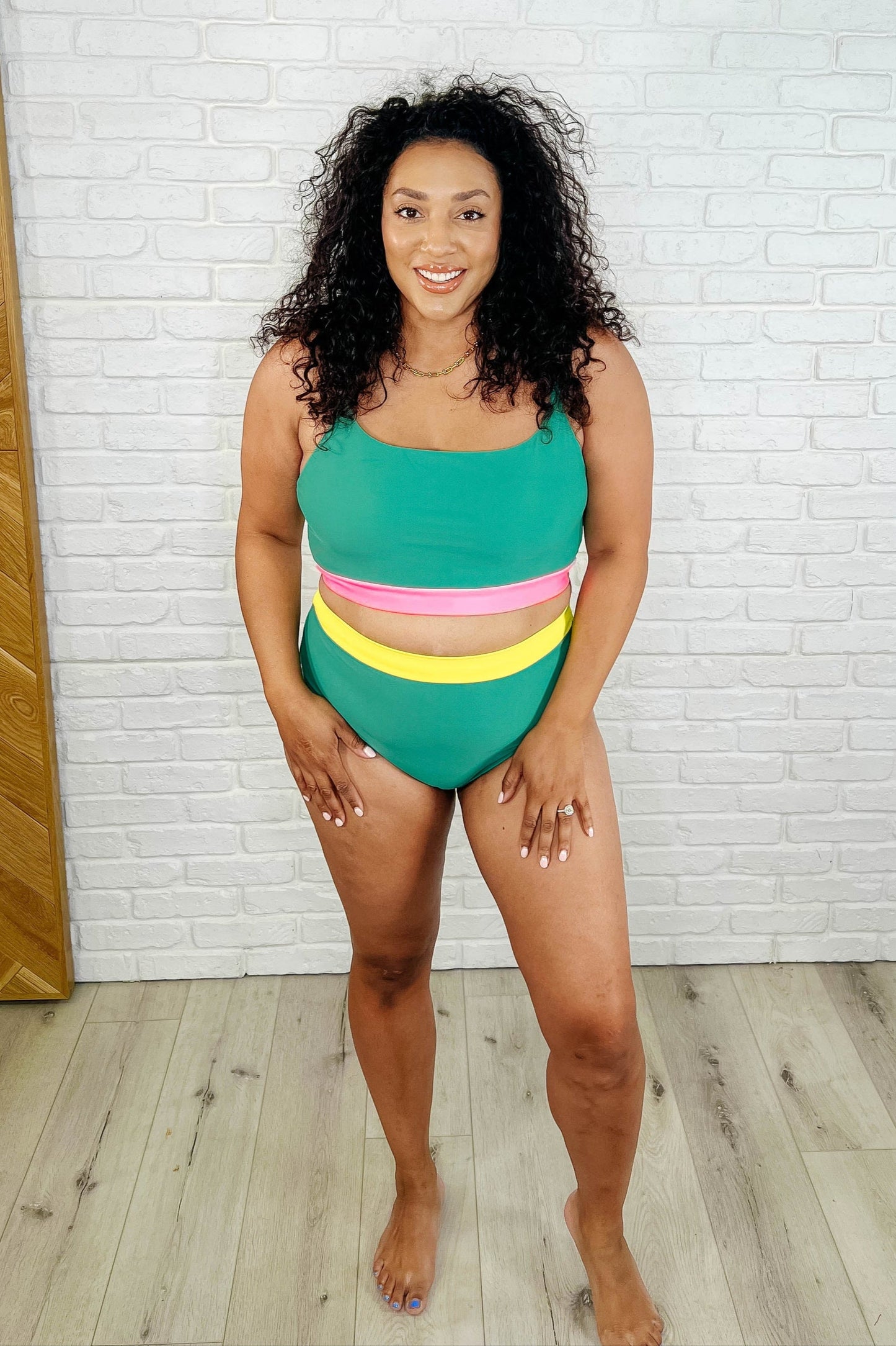 Women's Color Block Swim Top in green and neon pink featuring a square neckline, adjustable spaghetti straps with silver hardware, and a supportive shelf bra with removable cups.